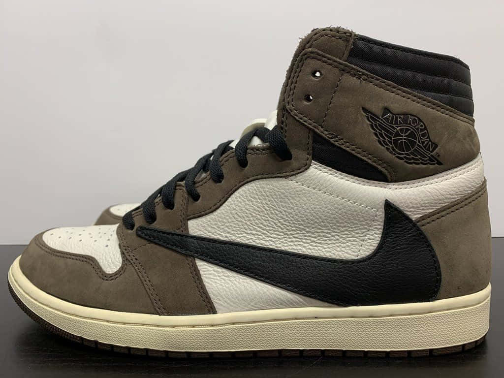 特寫一雙棕色、白色和黑色的Air Jordan高筒運動鞋，置於深色表面上。 — Michael B Jordan 壁紙