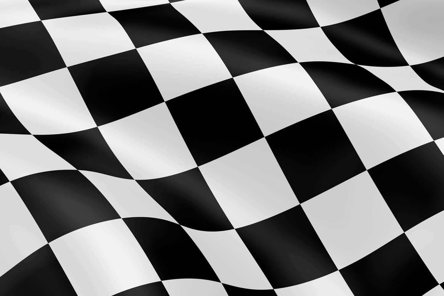 Checkered Flag 桌布 壁紙 — 一面充滿動感的黑白格紋賽車旗在明亮光線下飄揚，帶有清晰的摺痕。