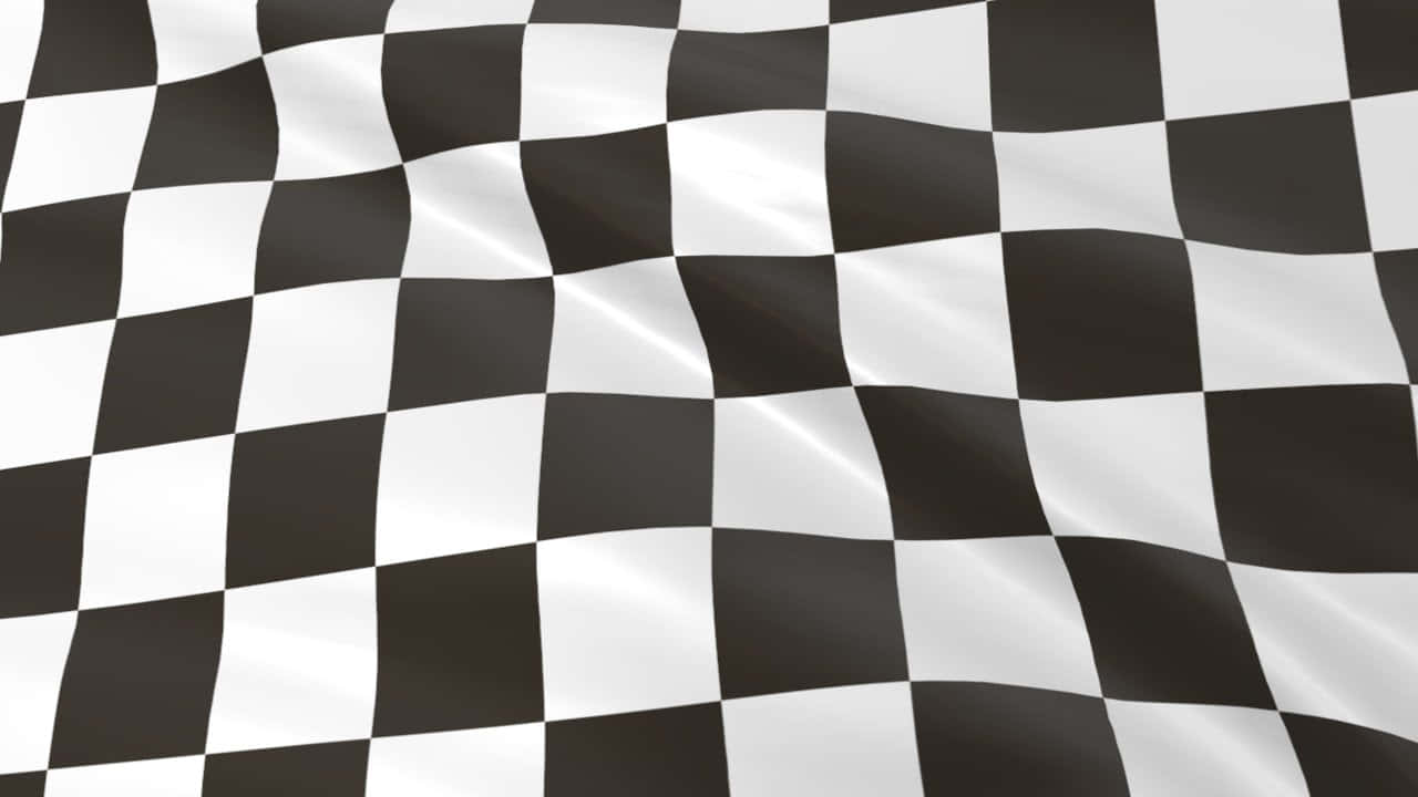 Chequered Flag 桌布 壁紙 — 一面動感的黑白方格賽車旗隨風飄揚，帶有清晰的摺痕和閃亮的高光。