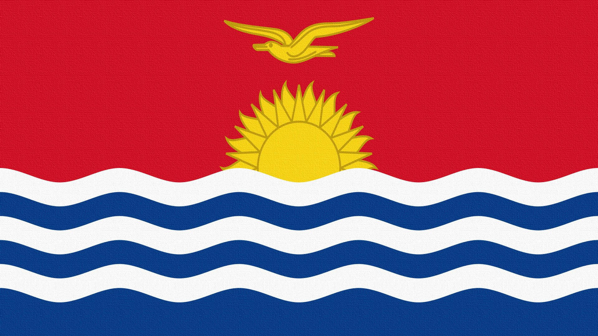 Kiribati 桌布 壁紙 — 一面大膽的紅色旗幟上，金色的太陽在藍白波浪條紋上升起，一隻金色的鳥在上方翱翔。