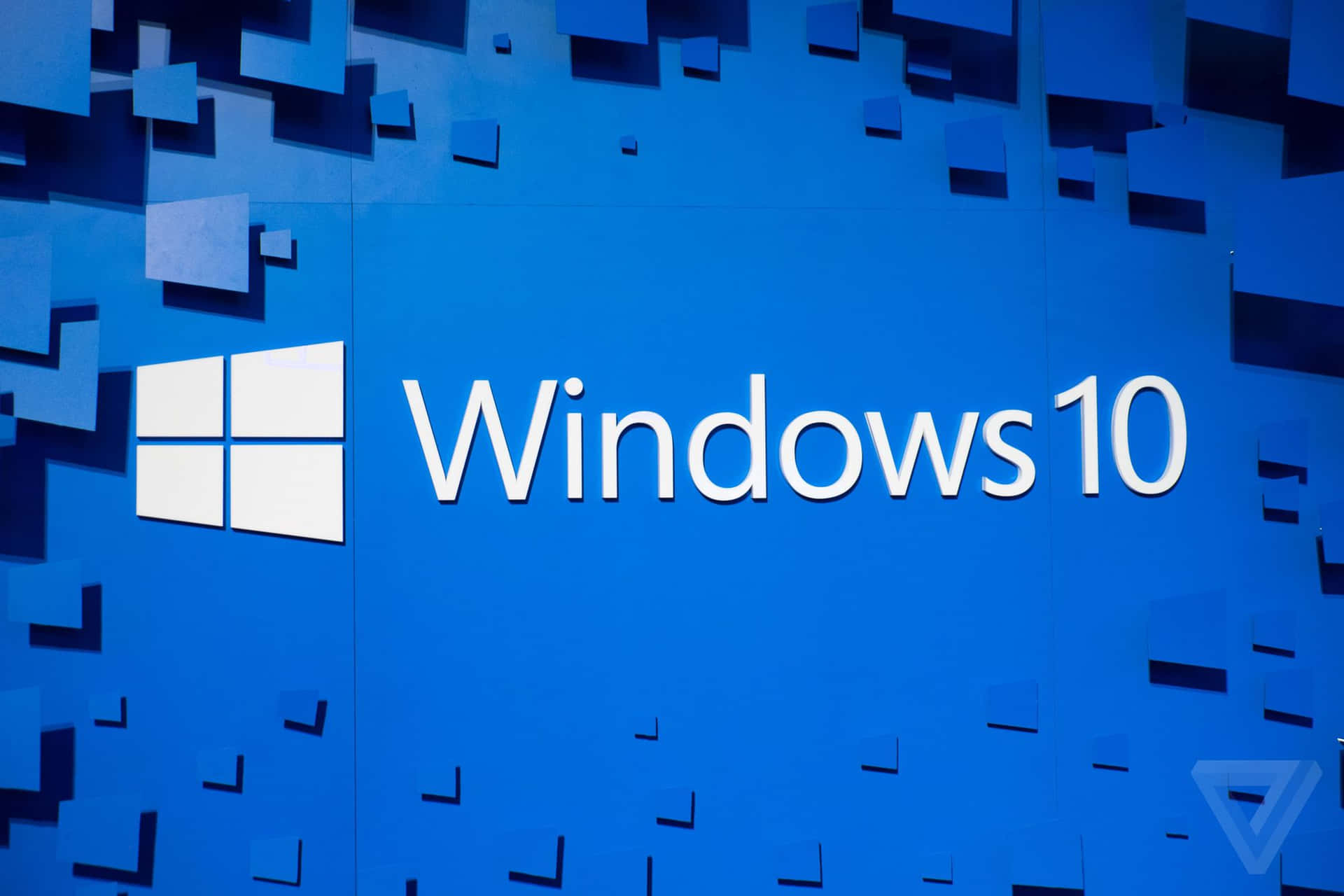 Windows 10標誌在藍色牆壁上，帶有漂浮的幾何形狀。 — Windows 10 GIF 壁紙