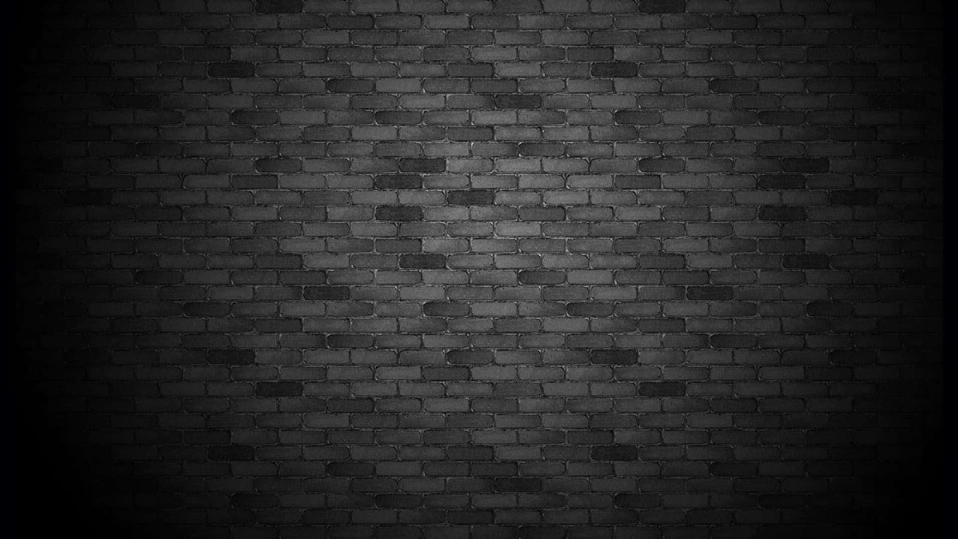 Dark Wall 桌布 壁紙 — 一面昏暗的磚牆，帶有聚光燈效果，邊緣逐漸消失在黑暗中。