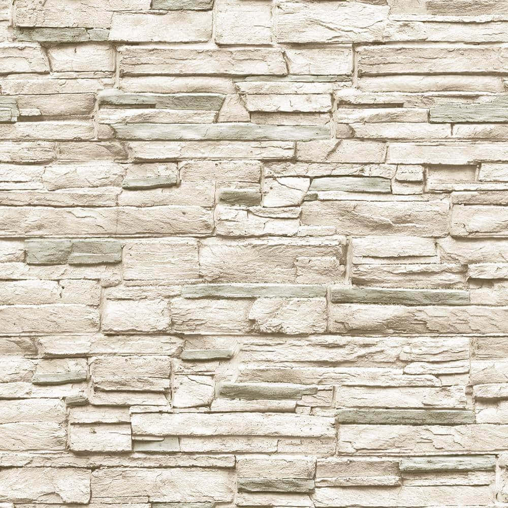 Brick Wall 桌布 壁紙 — 一面有紋理的石牆，由不規則堆疊的米色和灰色石頭組成，營造出質樸的自然圖案。