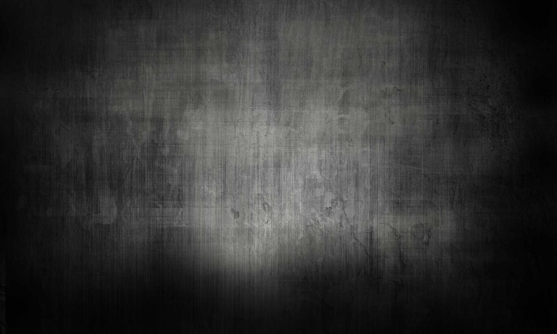 一面深色紋理牆壁被單一聚光燈照亮，營造出陰鬱氛圍。 — 純色動圖 壁紙