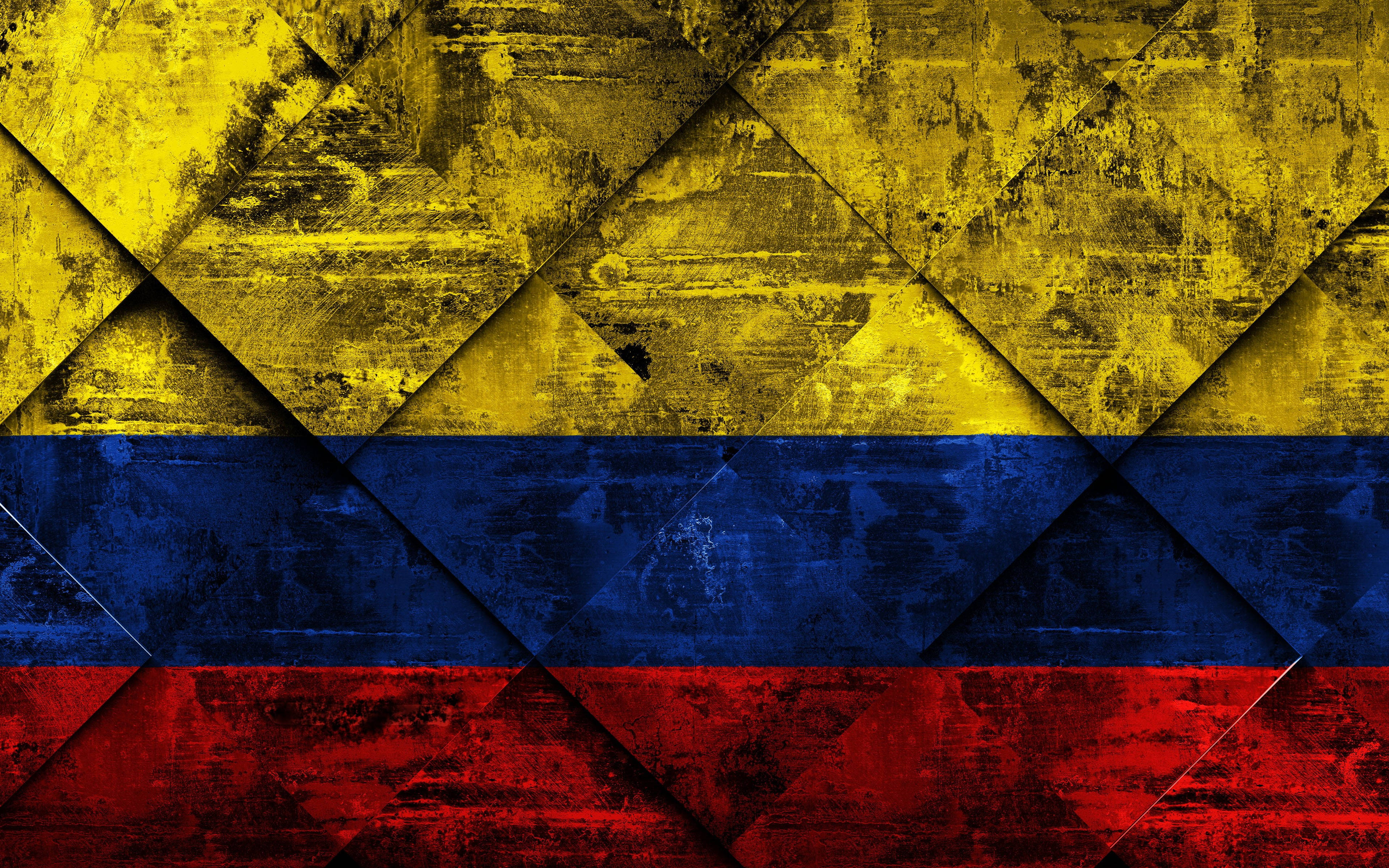 Colombia Flag 桌布 壁紙 — 一面經風化的哥倫比亞國旗，以黃、藍、紅條紋呈現幾何菱形圖案，並帶有紋理磨損效果。