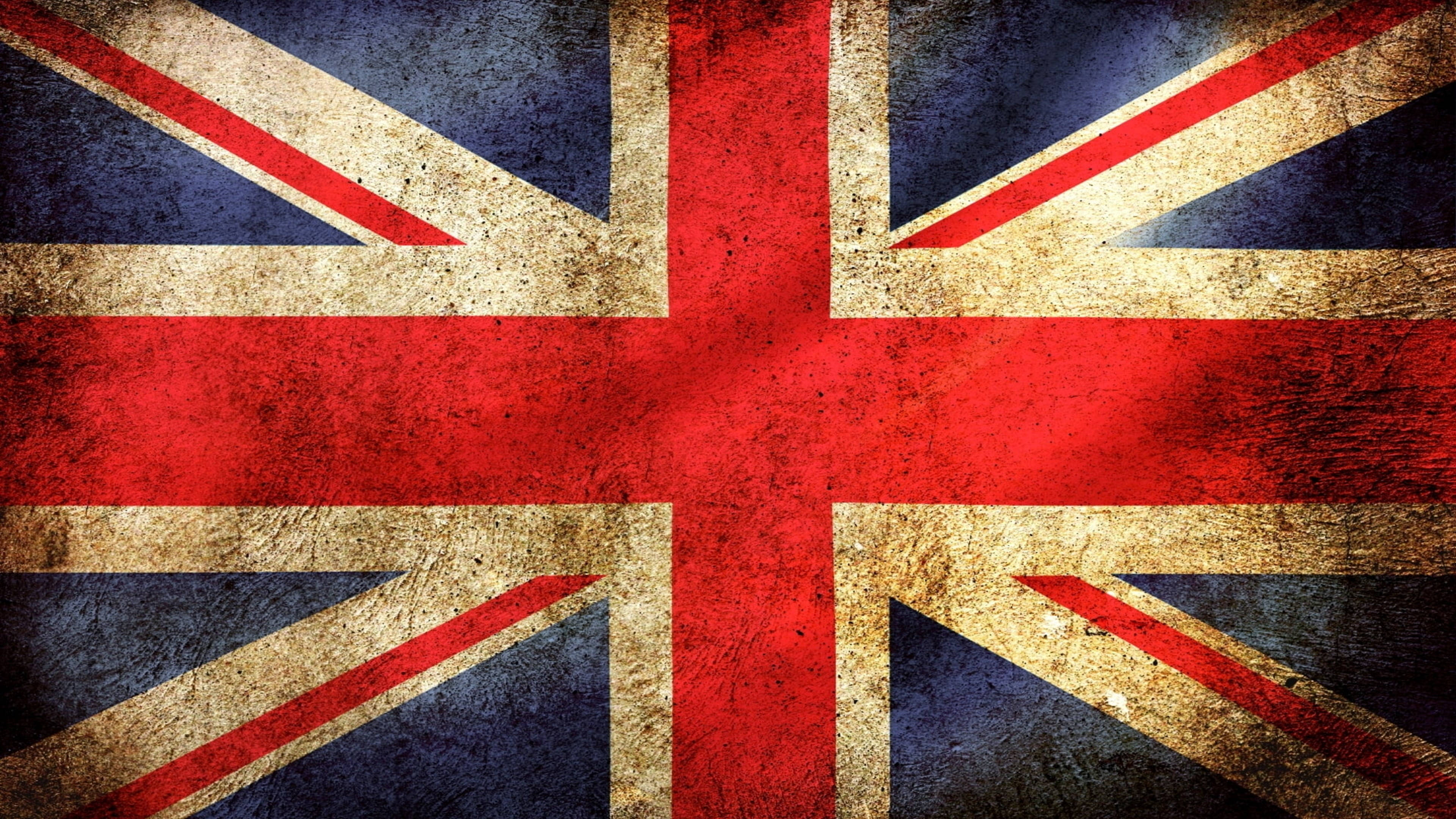 England 桌布 壁紙 — 一面經風化的英國國旗，帶有紋理的紅、白、藍條紋，顯示出歲月和磨損的痕跡。
