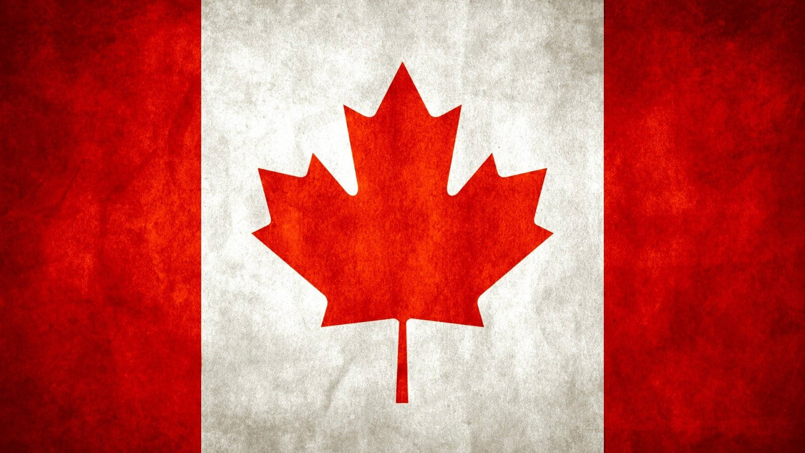 Canada Flag 桌布 壁紙 — 一面風化的加拿大國旗，白色條紋中央有紅色楓葉，兩側為紅色垂直條紋。