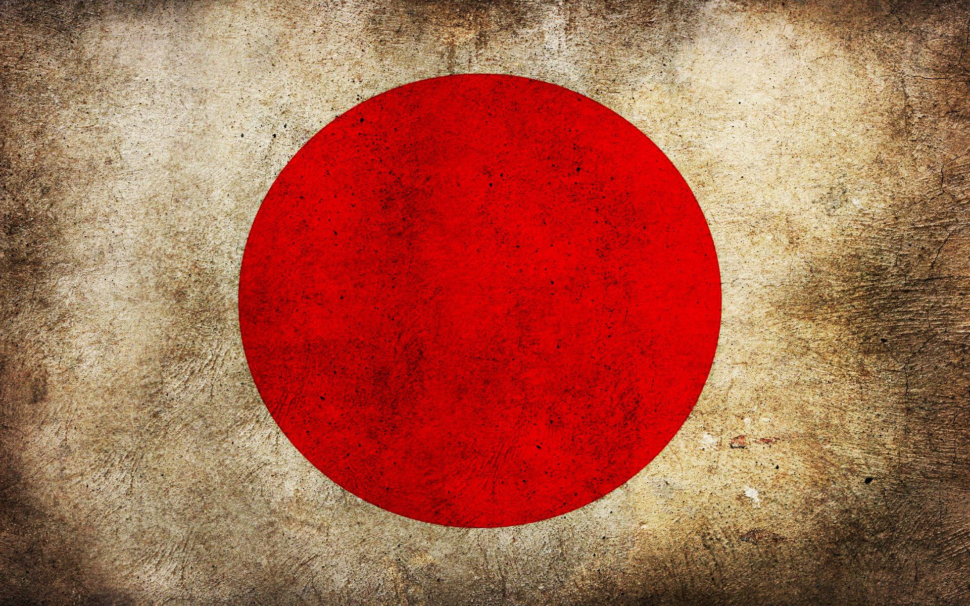 風化的日本國旗，在質感米色背景上有紅色圓圈。