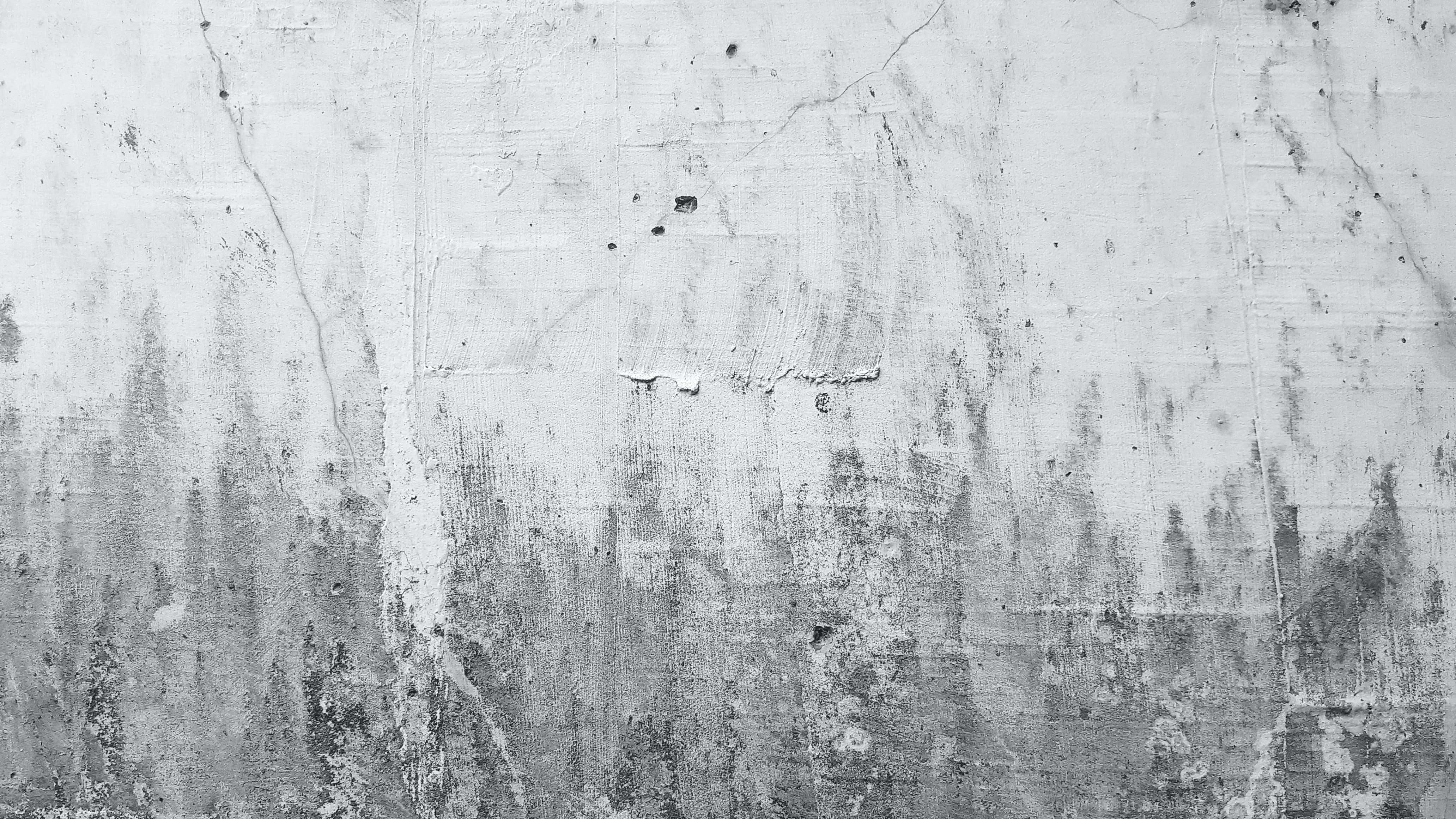 Gray Texture 桌布 壁紙 — 一面風化的混凝土牆，油漆剝落，裂縫顯露灰色和白色紋理。