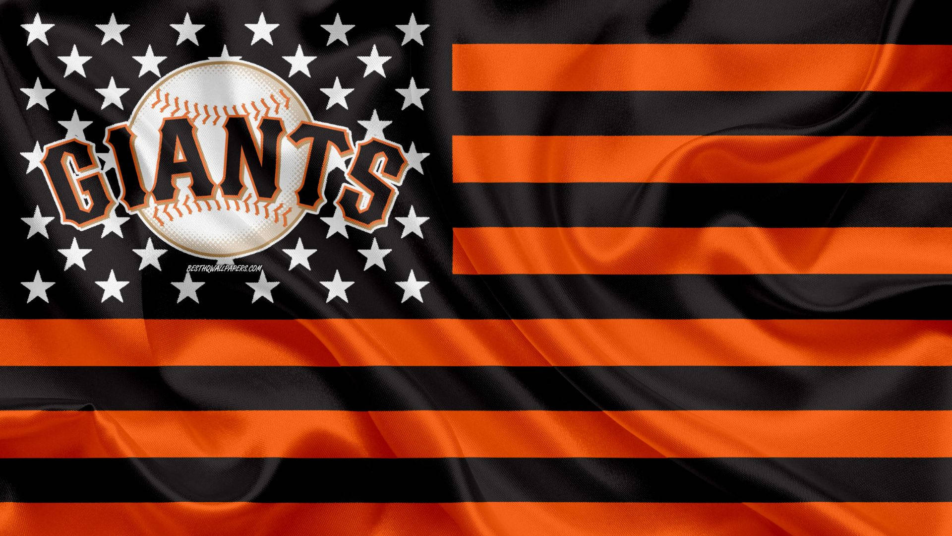 Giants 桌布 壁紙 — 一面飄揚的旗幟，帶有黑色和橙色條紋及白色星星，並有棒球和「GIANTS」文字。