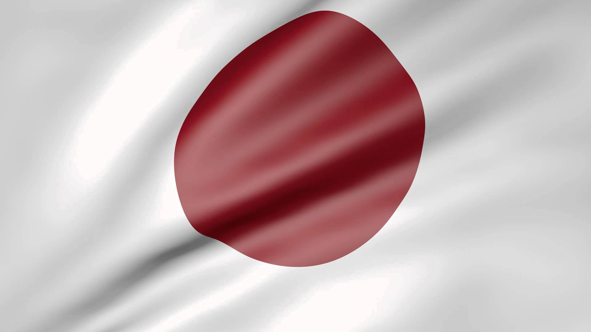 日本國旗在風中飄揚，白色背景上有紅色圓圈。