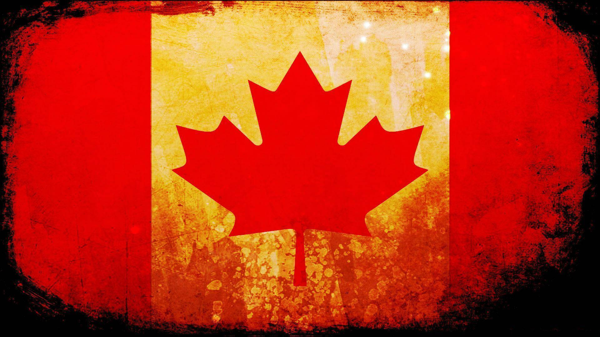 Canada Flag 桌布 壁紙 — 一面飽經風霜的加拿大國旗，中央有醒目的紅色楓葉，位於黃色背景上，兩側有紅色條紋，呈現頹廢質感和變暗的邊緣。