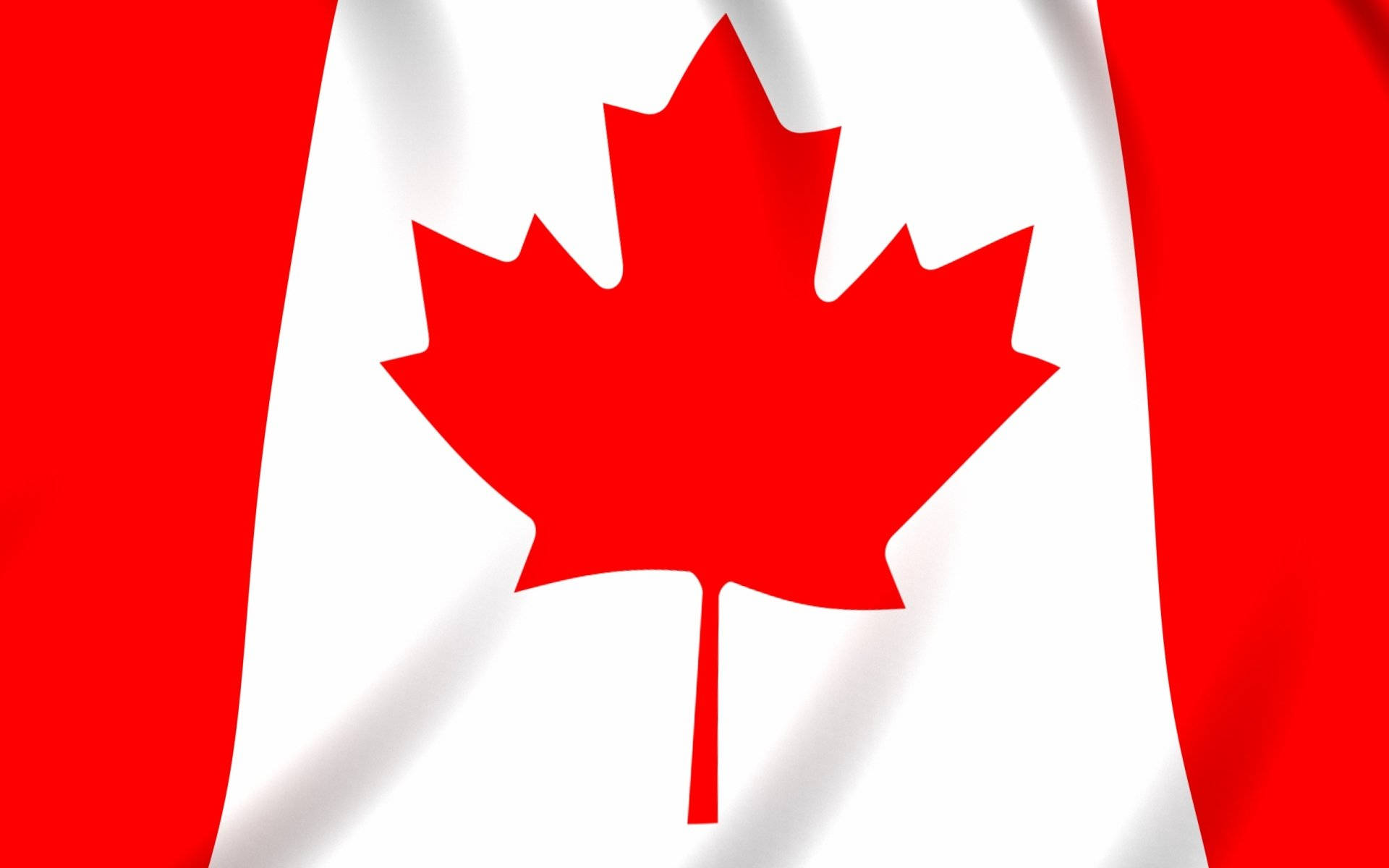 Canada Flag 桌布 壁紙 — 一面鮮豔的紅白加拿大國旗，中央有醒目的楓葉，在風中輕輕飄揚。