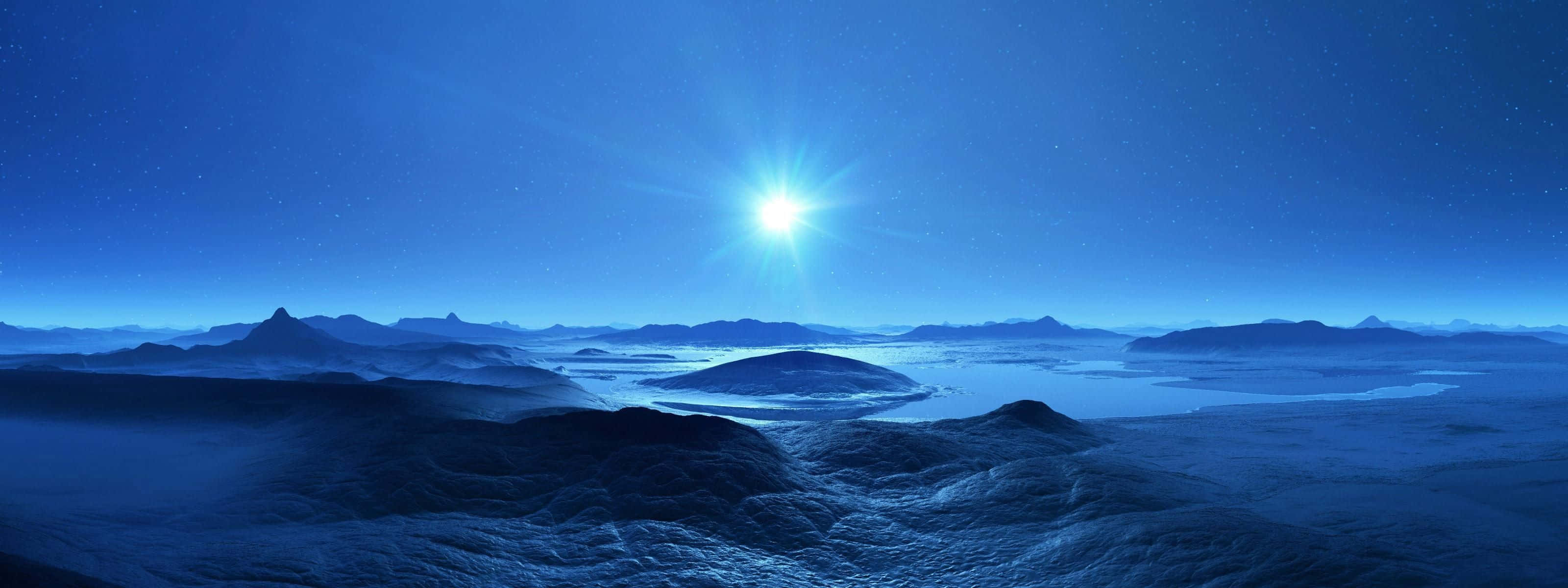 Best Monitor 桌布 壁紙 — 一顆光芒四射的星星在霧氣瀰漫的外星景觀上空明亮地閃耀，下方是連綿起伏的丘陵和遠山，背景是繁星點點的藍色天空。