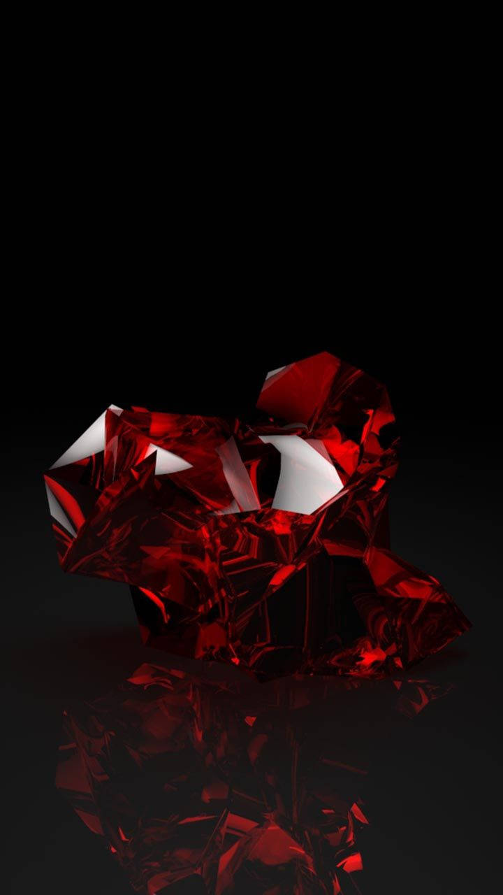 Red Crystal 桌布 壁紙 — 一顆切割面紅水晶在黑色虛空中閃耀著銳利高光，下方投射出鏡面倒影。