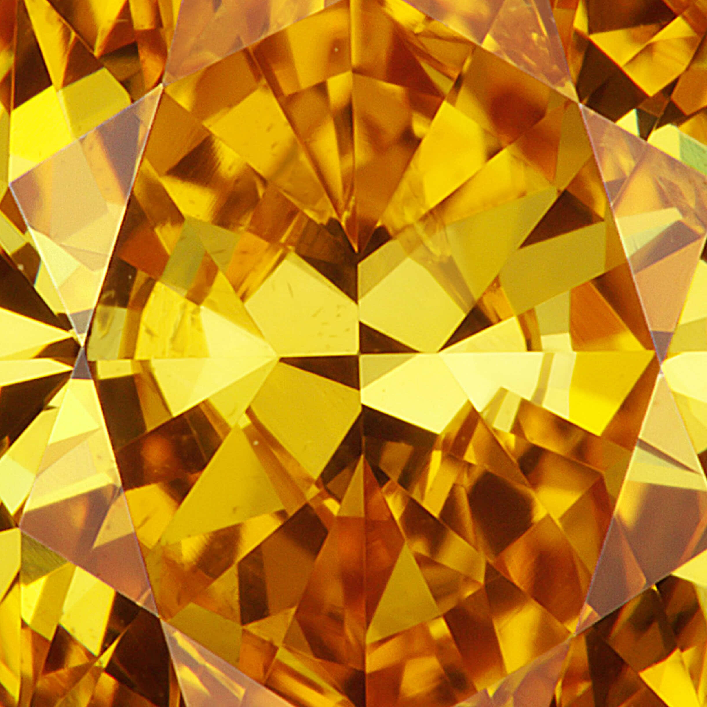 Yellow Diamond 桌布 壁紙 — 一顆切割面金黃色寶石的近距離特寫，透過幾何切割散發出溫暖的光芒。