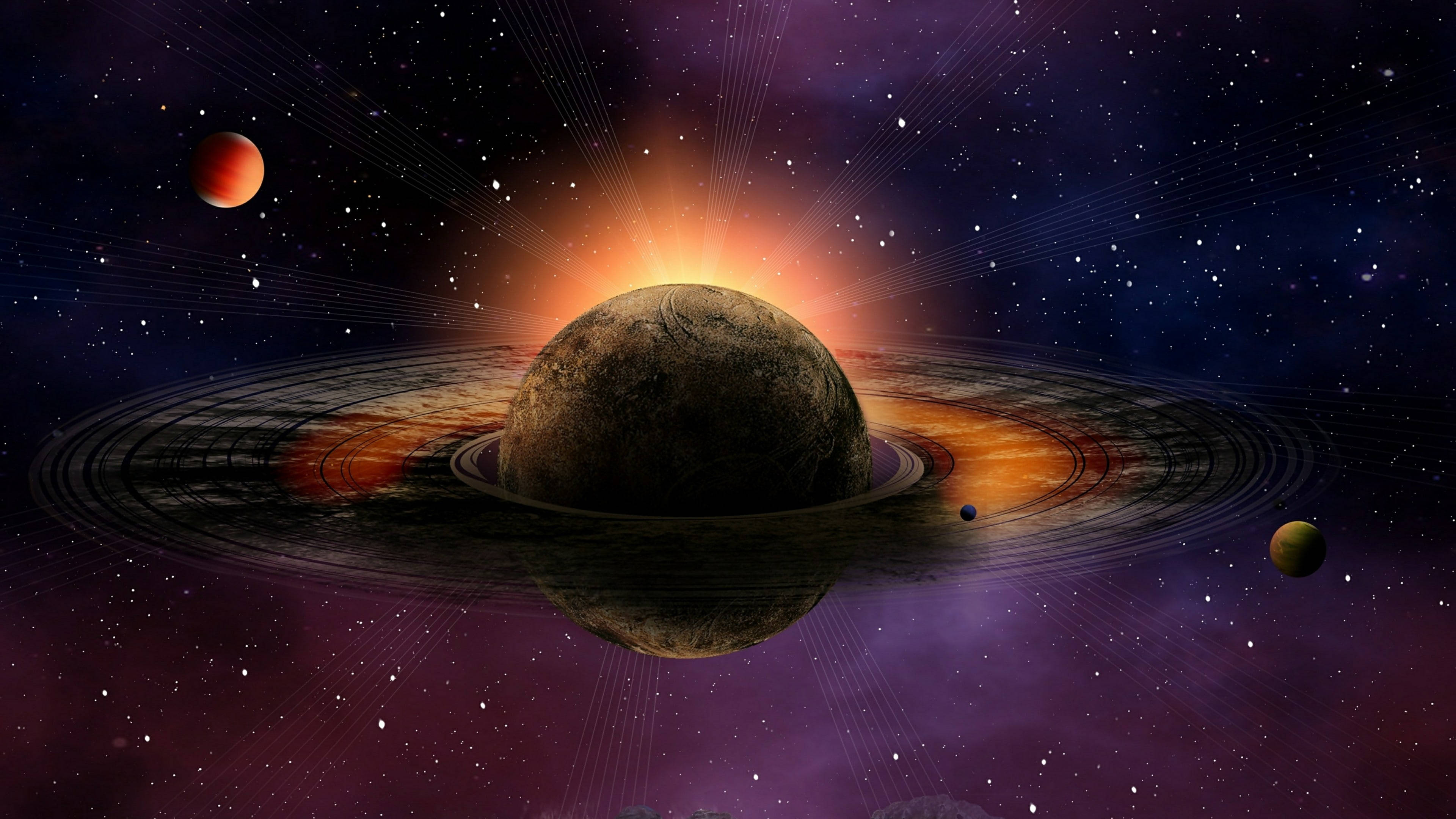 土星 桌布 壁紙 — 一顆宏偉的環狀行星在星光宇宙背景下發出燦爛的太陽光芒，並有繞行的衛星。