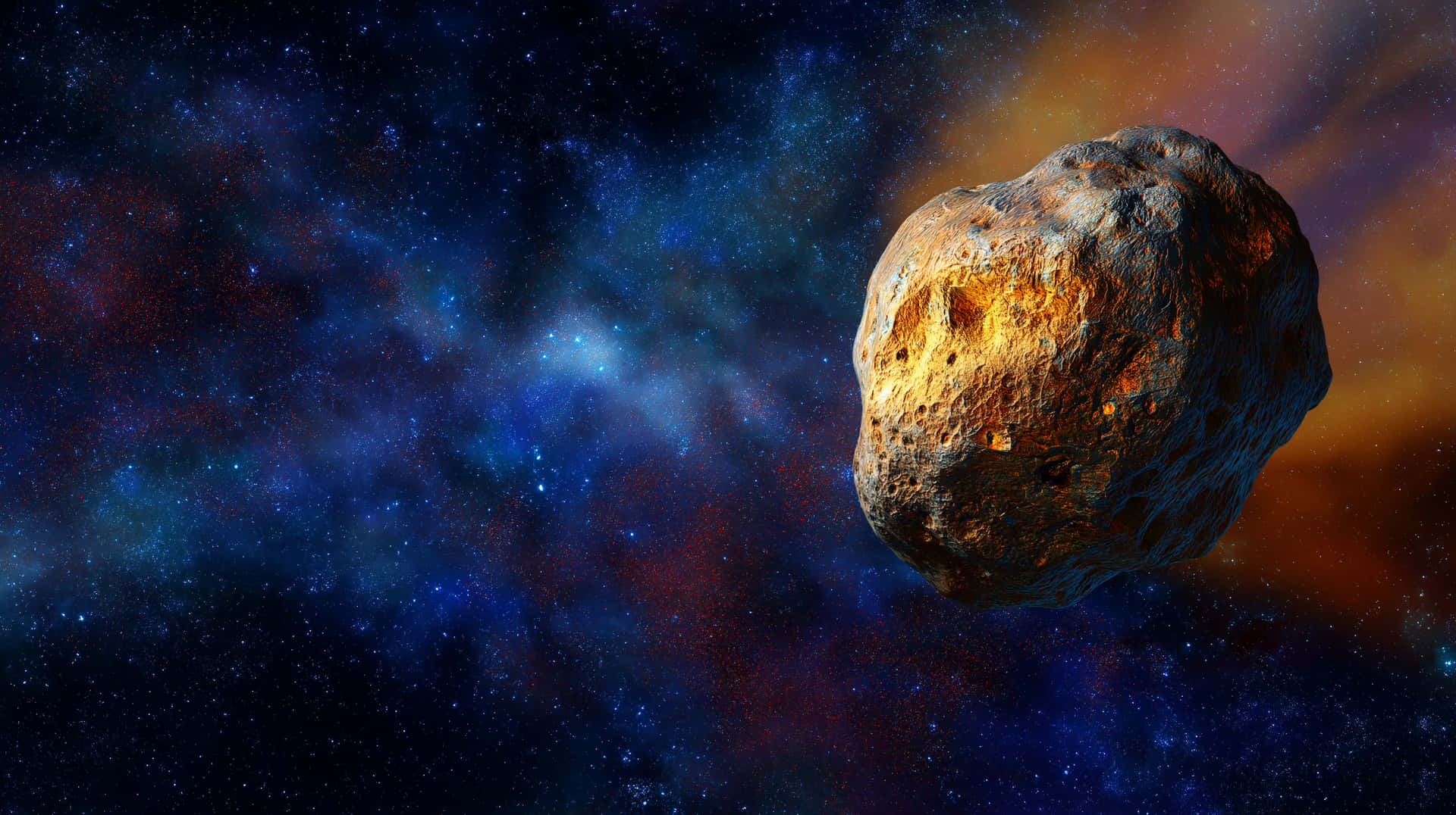 Textured Meteorite Drifting Through Distant Starfield 壁紙 — 一顆崎嶇的小行星在充滿活力的宇宙星雲中漂流，星雲散發著藍色、紅色和橙色的色調，背景是星場。