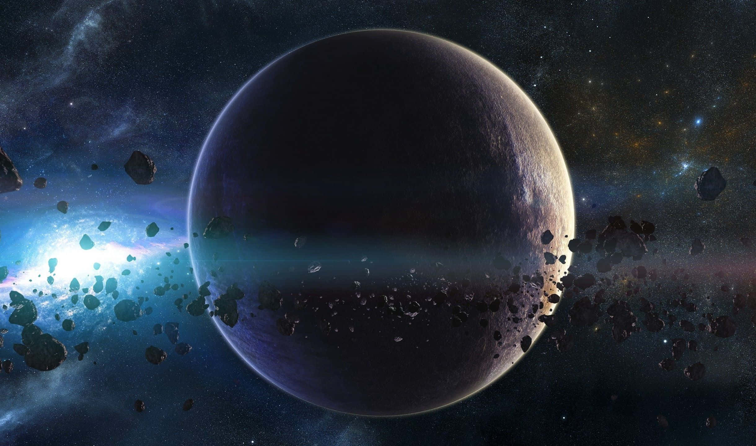 2440x1440 桌布 壁紙 — 一顆巨大的黑暗行星在太空中隱現，周圍環繞著漂浮的小行星和發光的宇宙星雲。