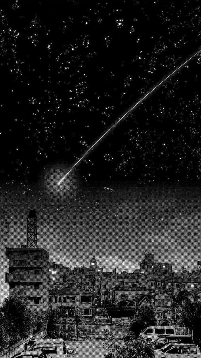 桌布 壁紙 — 一顆明亮的流星劃過繁星點點的夜空，下方是寧靜的市區，窗戶透出燈光，路邊停著汽車。