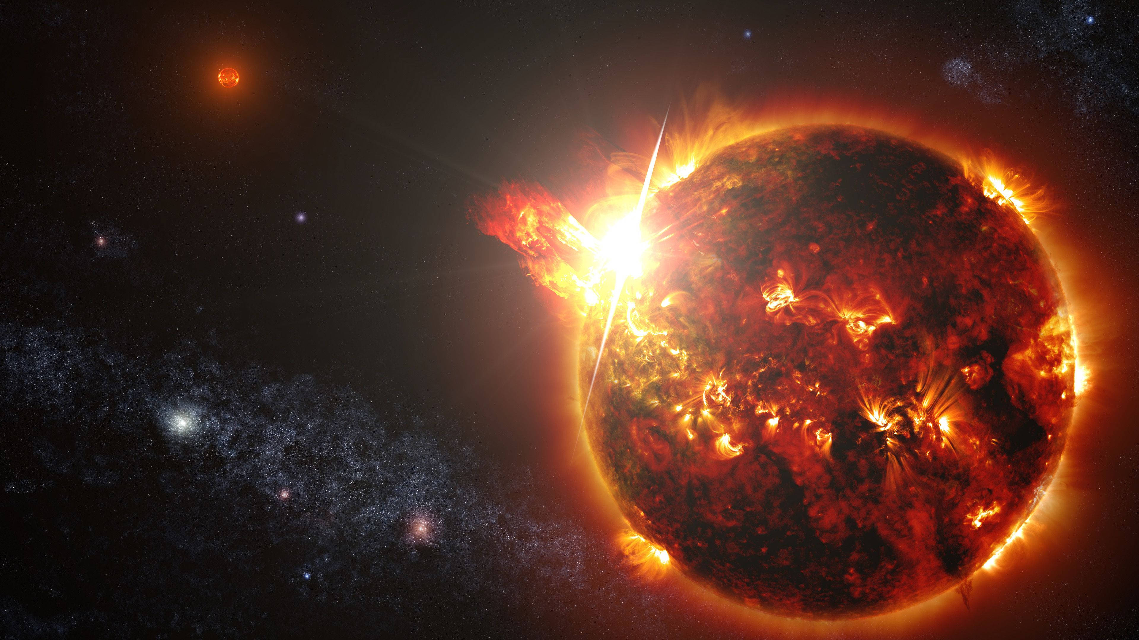 太陽 桌布 壁紙 — 一顆熾熱的太陽在佈滿星星的宇宙背景下爆發太陽耀斑，背景有遙遠的星系。