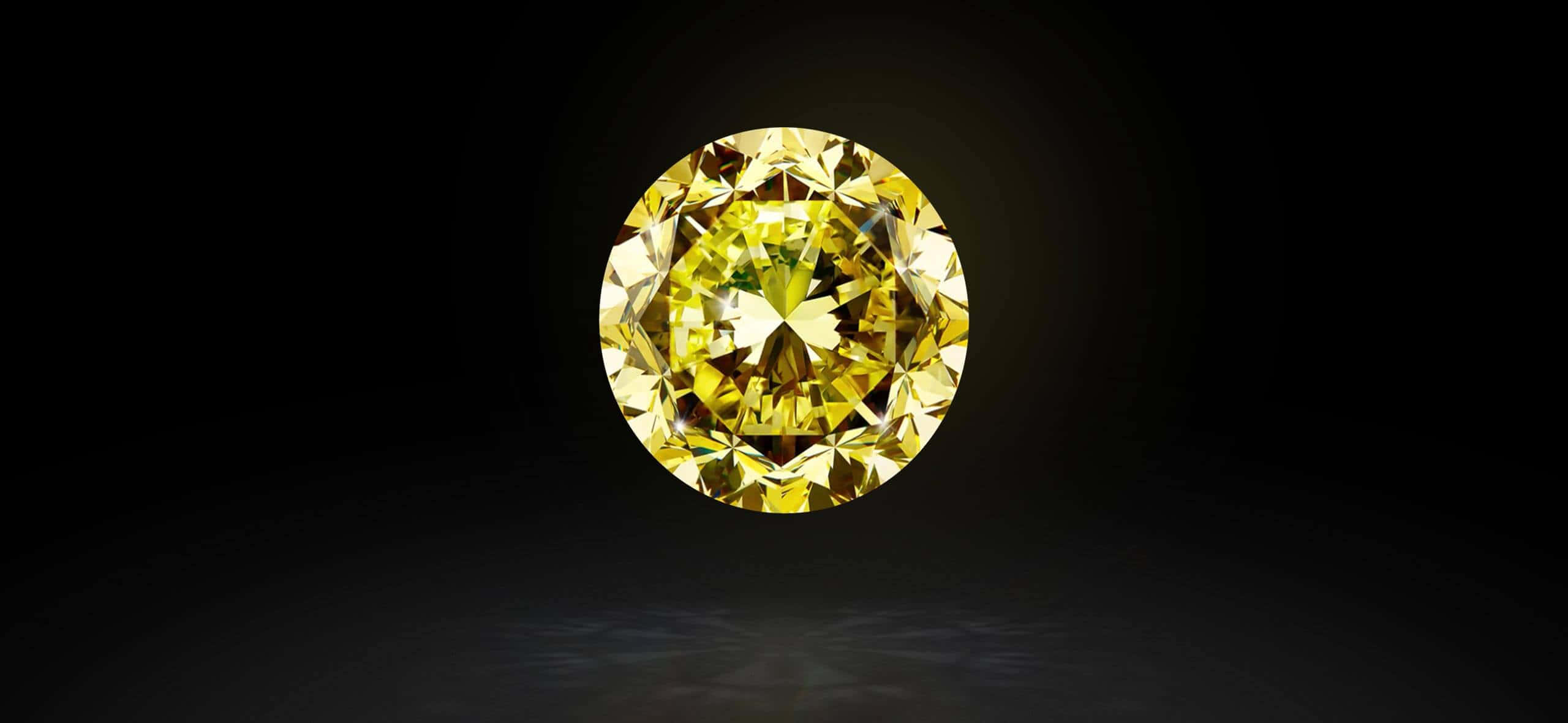 Yellow Diamond 桌布 壁紙 — 一顆璀璨的黃鑽在深邃的黑色虛空中閃耀著火彩般的刻面，在下方反射面上投下柔和的光芒。
