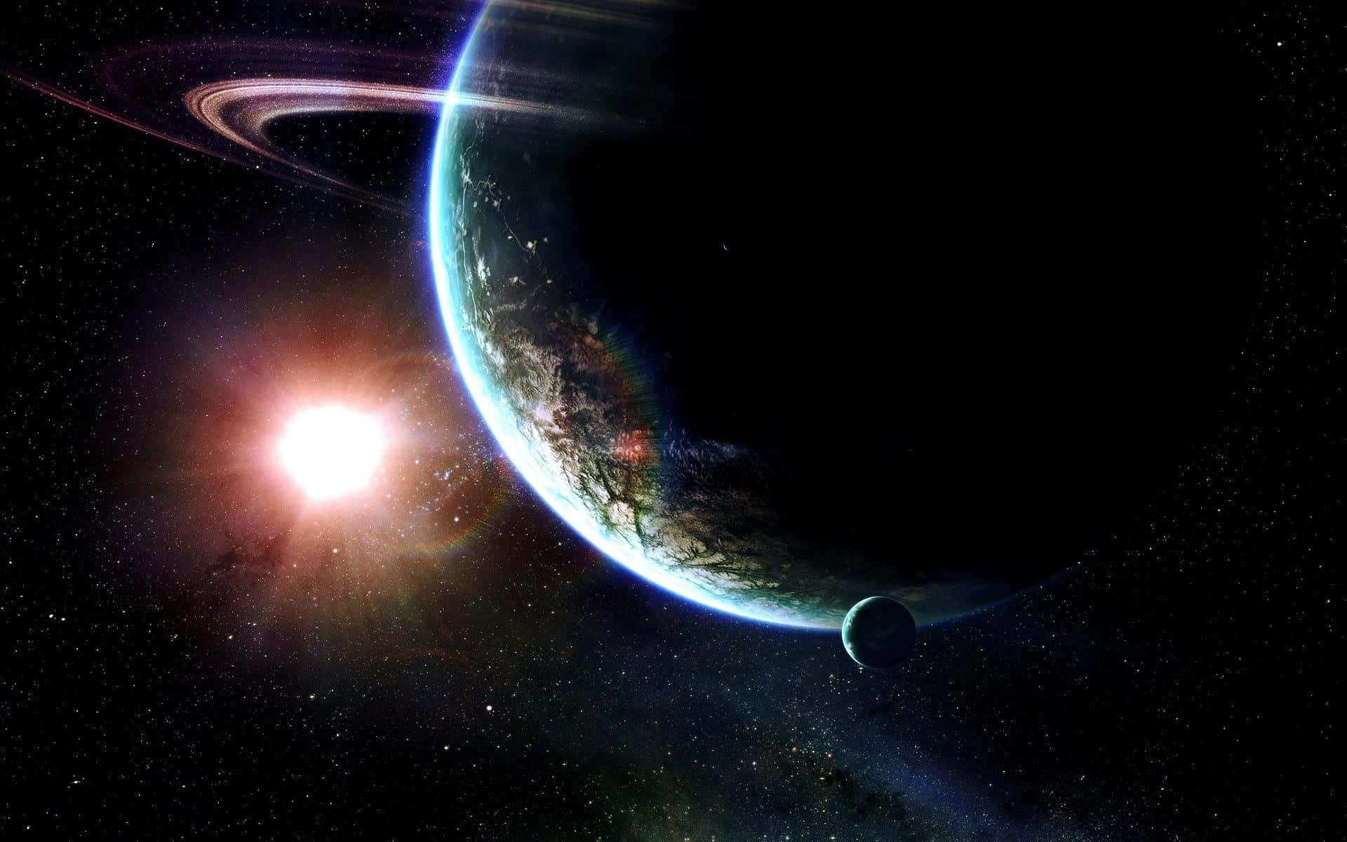 Black Space 桌布 壁紙 — 一顆發光的太陽照亮了一顆帶有光環和衛星的藍色行星，背景是繁星點點的宇宙。