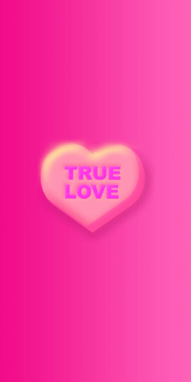 愛心 桌布 壁紙 — 一顆發光的愛心形狀糖果，上面有 true love 字樣，漂浮在充滿活力的粉紅色漸層背景上。