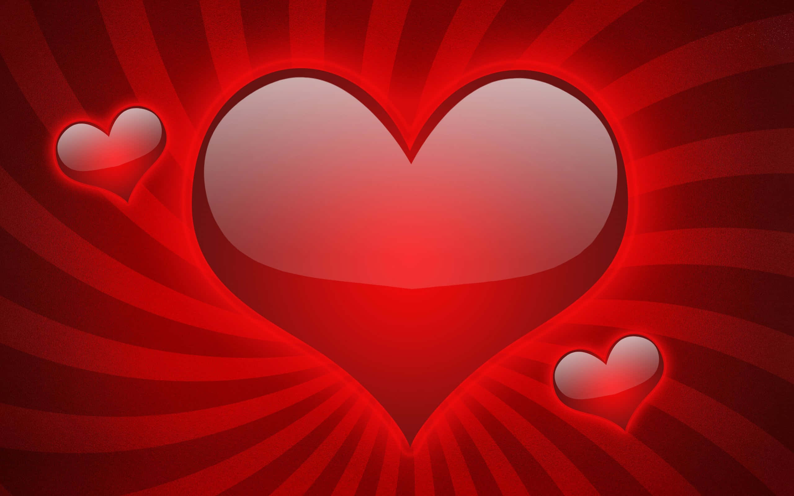 Red Heart 桌布 壁紙 — 一顆發光的紅色心臟在旋轉的紅色背景上散發溫暖，附近漂浮著兩顆較小的愛心。