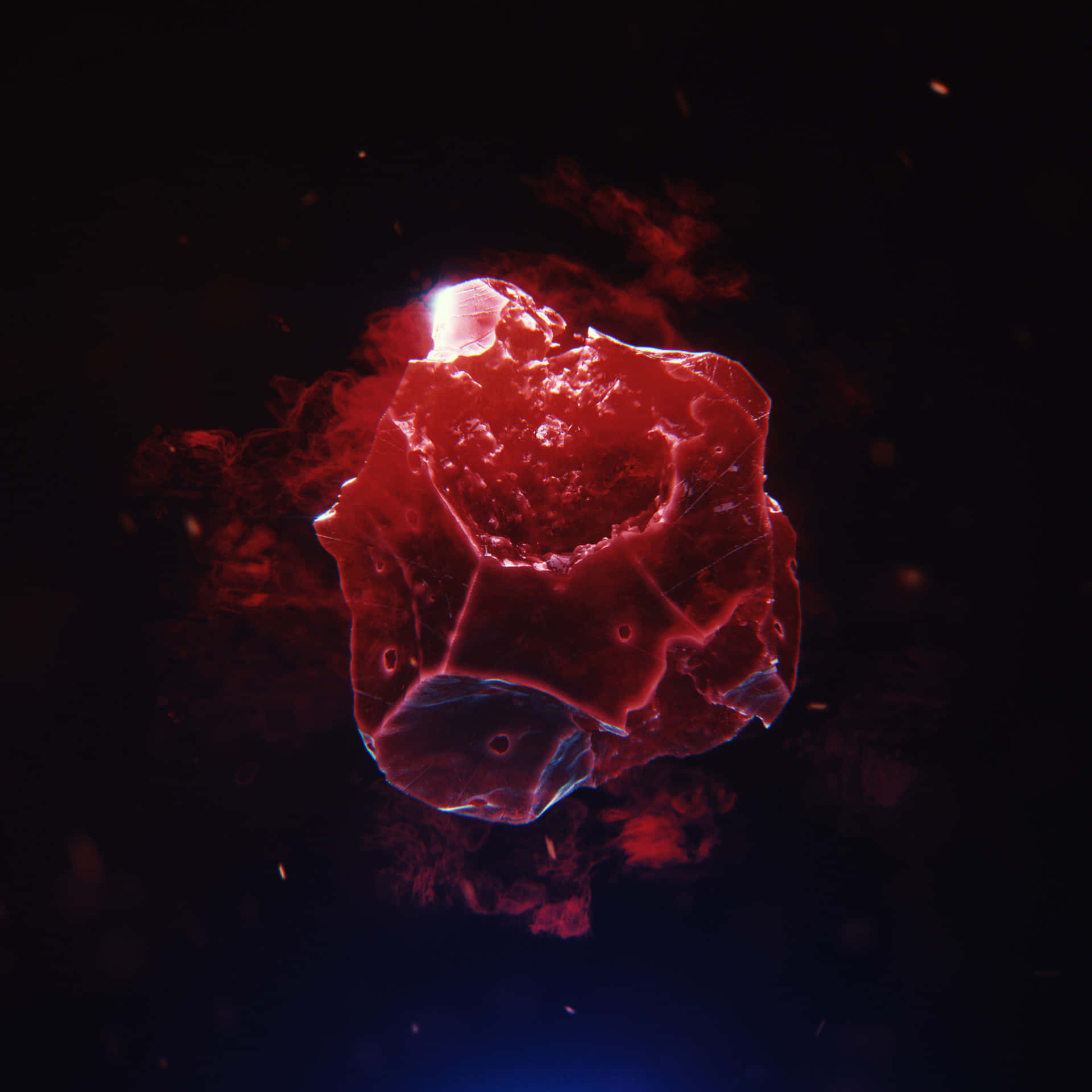 Reality Stone 桌布 壁紙 — 一顆發光的紅色水晶小行星漂浮在深空之中，周圍有熾熱的粒子旋轉。