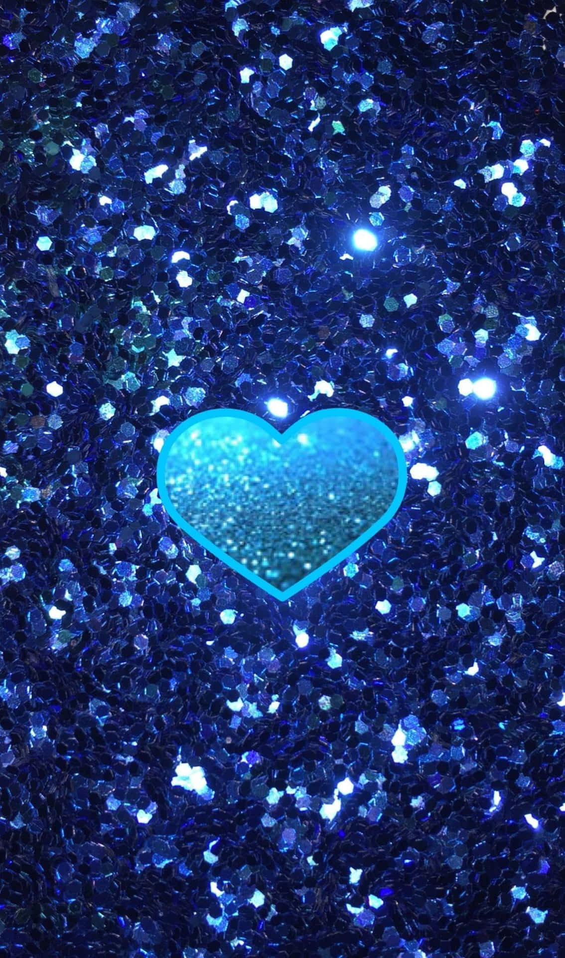 Heart 桌布 壁紙 — 一顆發光的綠松色心臟在一片閃爍的藍色亮粉粒子中閃耀。