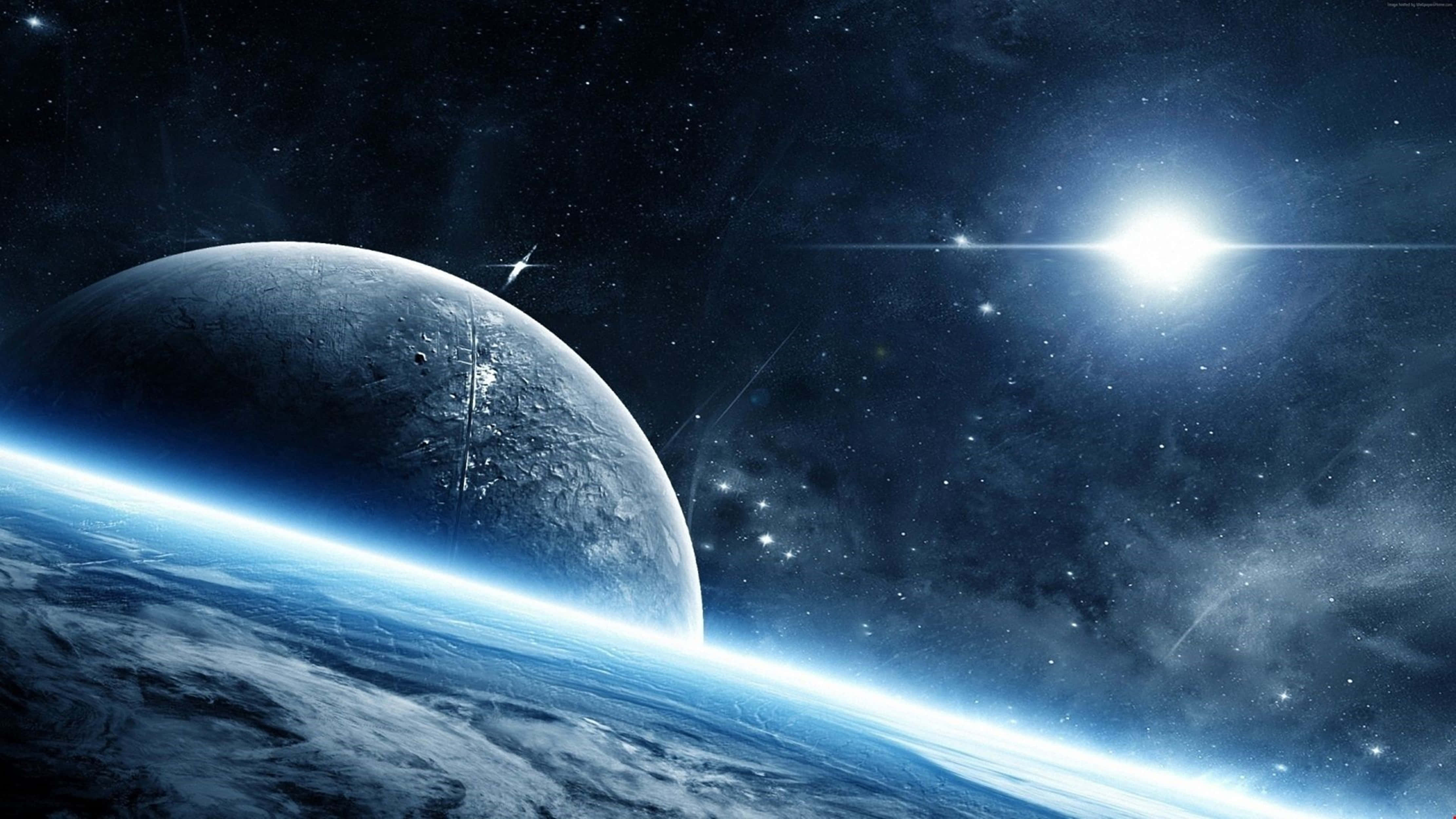 月光 桌布 壁紙 — 一顆發光的藍色行星在星空中彎曲，明亮的太陽在佈滿隕石坑的月球後面照耀。