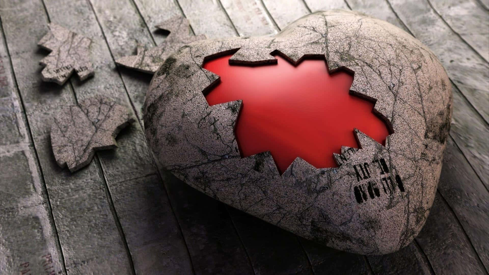 Heartbreaks 桌布 壁紙 — 一顆裂開的石心，邊緣參差不齊，露出鮮紅色的內部，擱在風化的木板上，附近散落著碎片。