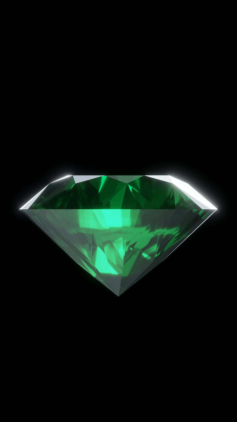 Emerald 桌布 壁紙 — 一顆閃耀的綠色鑽石在純黑背景上散發著內在光芒。