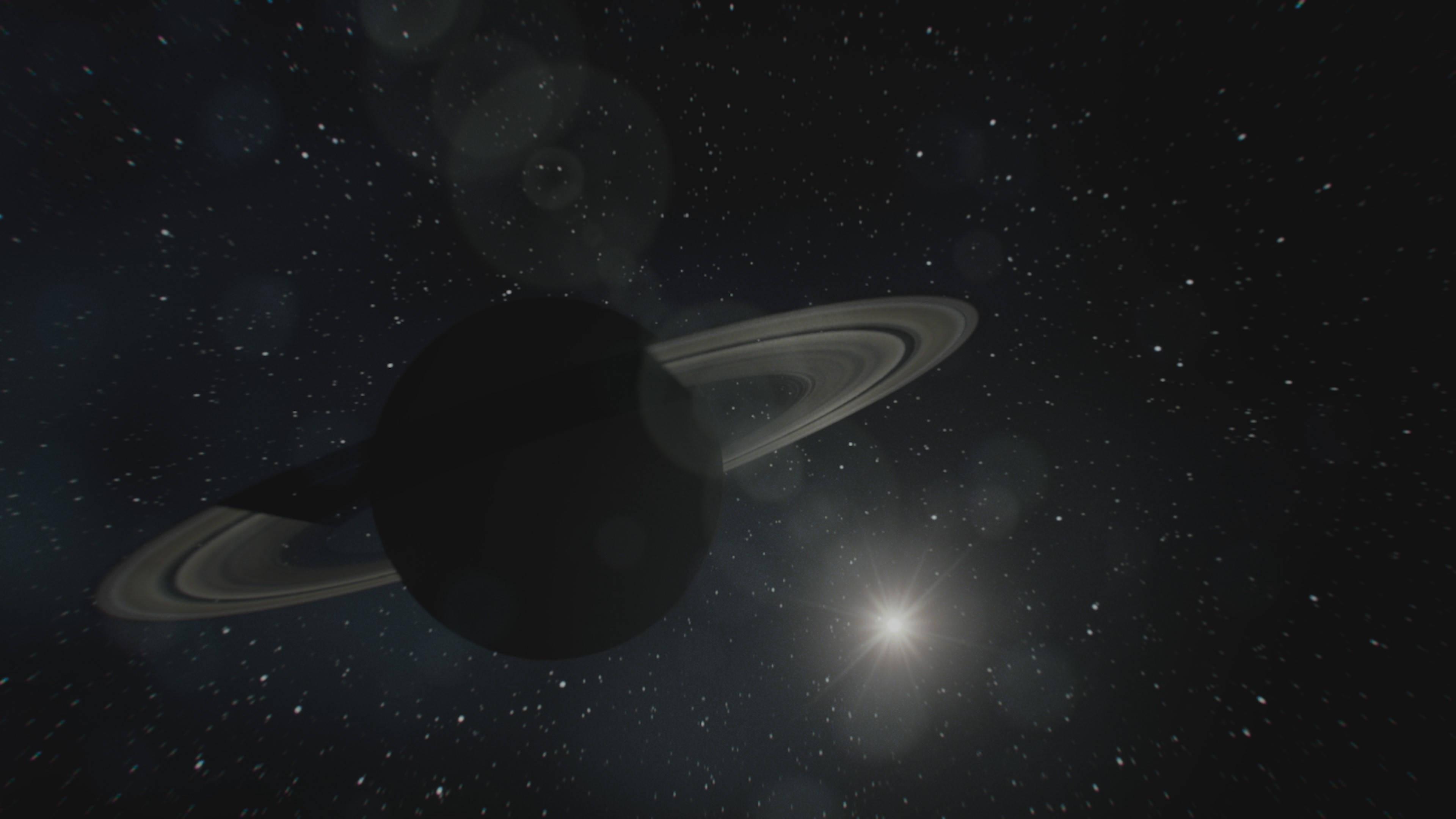 Black Planet 桌布 壁紙 — 一顆雄偉的土星帶有其標誌性的光環，在星空中柔和地發光，附近有一顆明亮的星星閃耀。