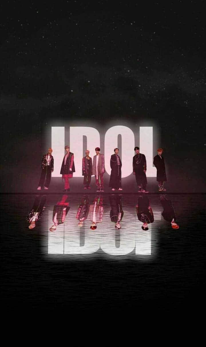 The Idol 桌布 壁紙 — 七位時尚偶像站在閃爍的「IDOL」標誌前，背景是繁星點點的夜空，下方有完美的倒影。