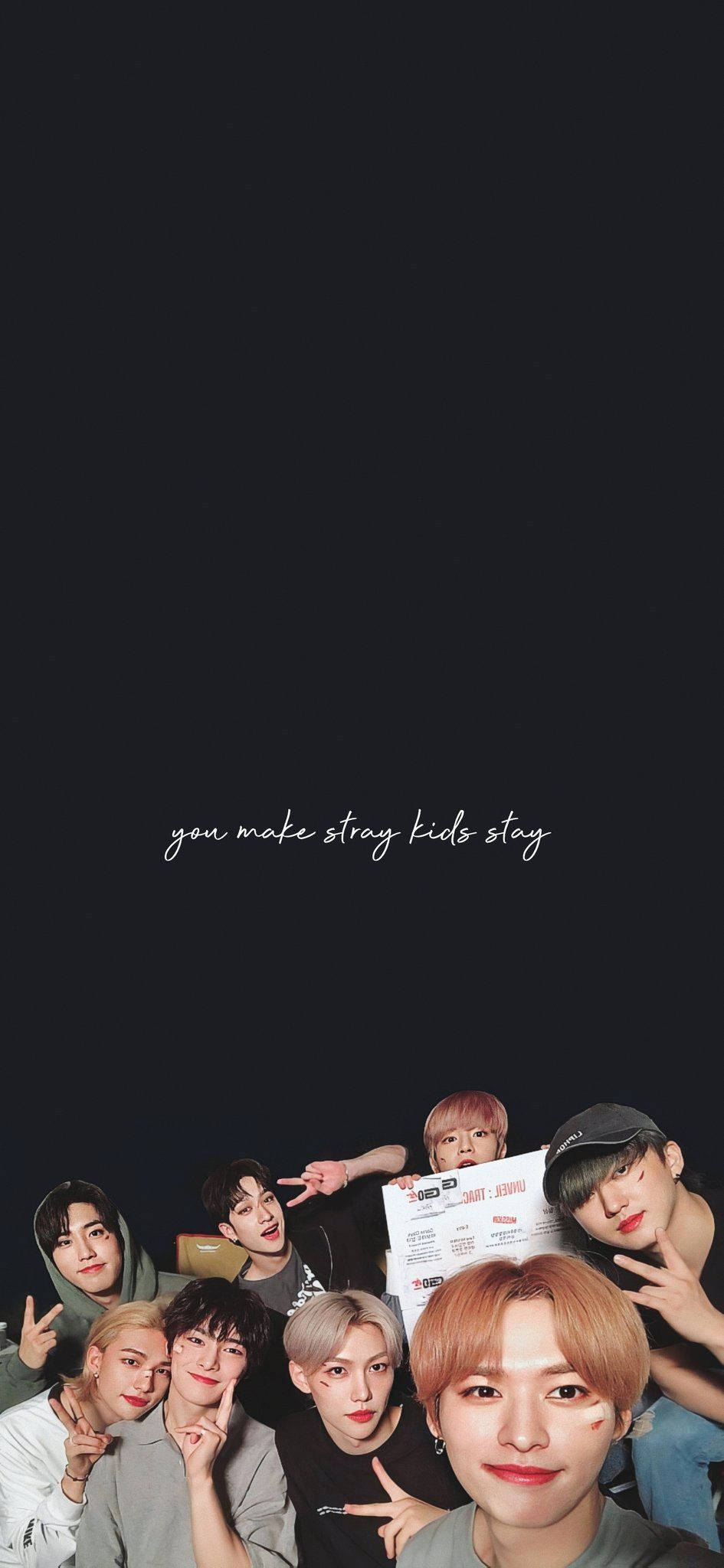 Stray Kids 桌布 壁紙 — 七位身穿休閒服裝的年輕男性在黑色背景前愉快地擺姿勢，並帶有文字 you make stray kids stay。