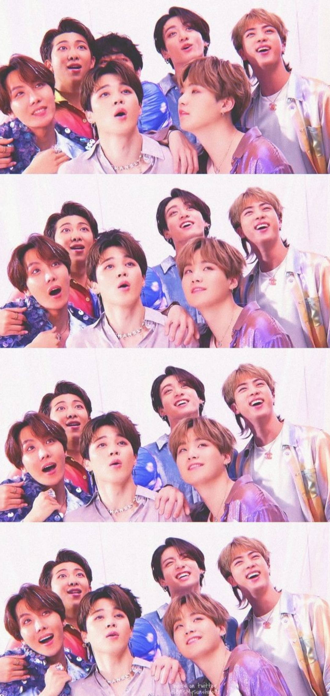 BTS 鎖定螢幕 桌布 壁紙 — 七位身穿色彩繽紛服裝的年輕男性在明亮的攝影棚中以歡樂的表情俏皮地擺姿勢。