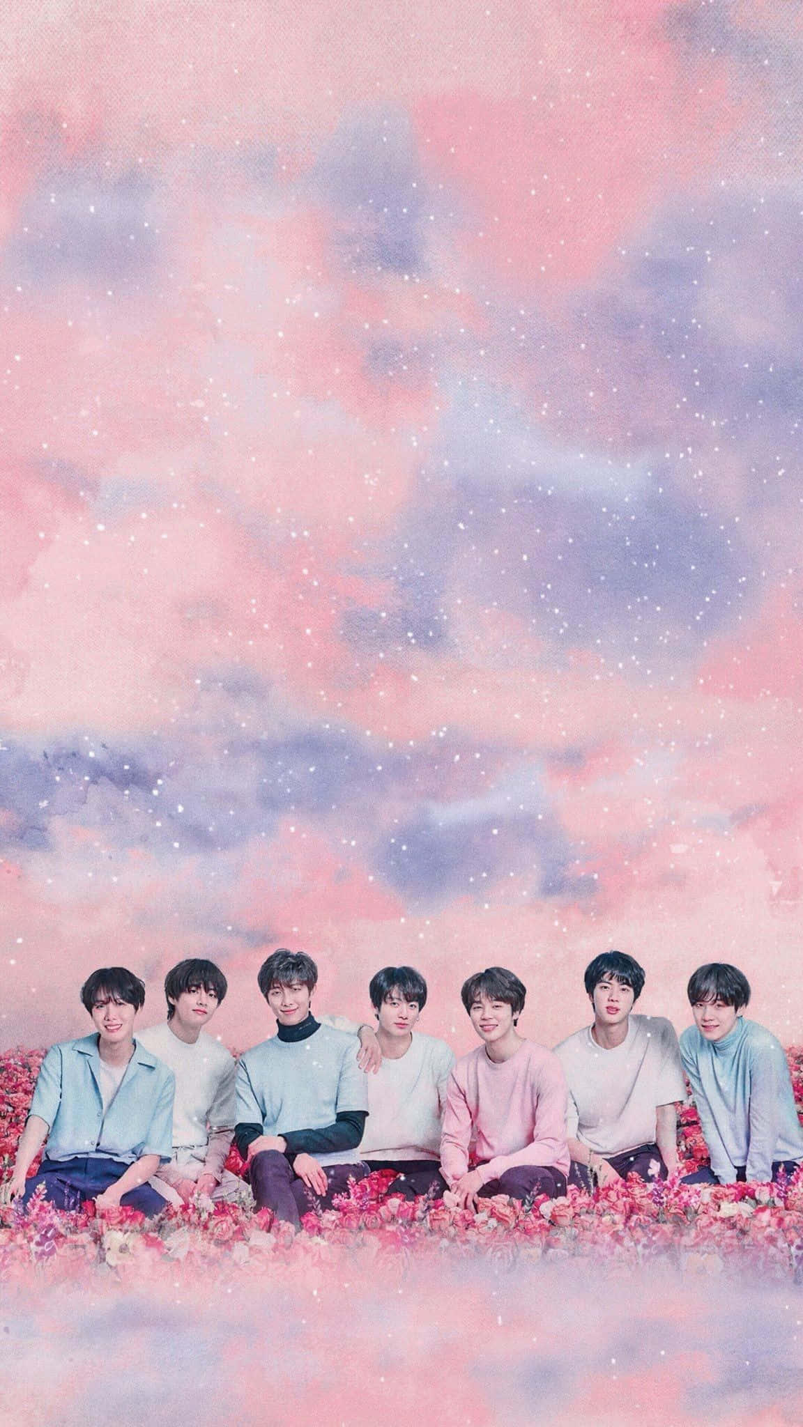 BTS 桌布 壁紙 — 七個年輕男子坐在一片粉紅色花田裡，上方是充滿星星的夢幻粉彩天空。