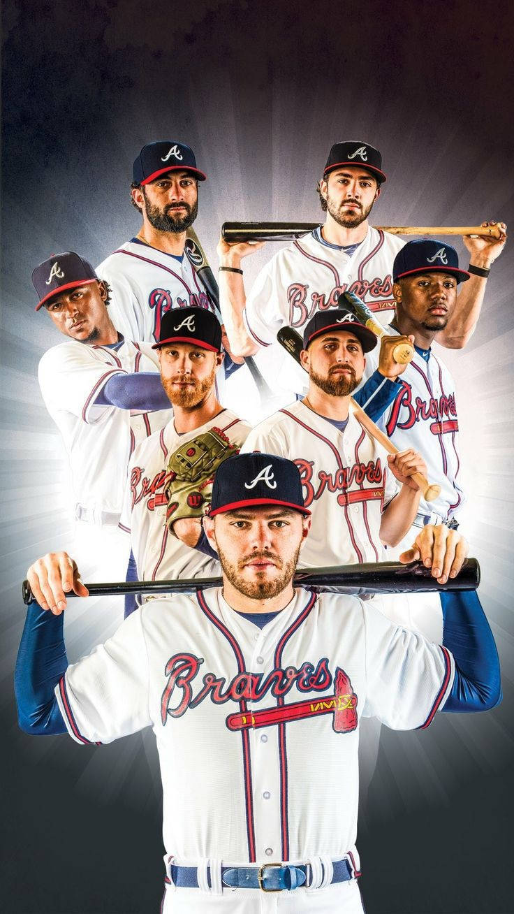 Freddie Freeman 桌布 壁紙 — 七名身穿白色球衣的亞特蘭大勇士隊棒球選手，在黑暗放射光背景前手持球棒擺姿勢。