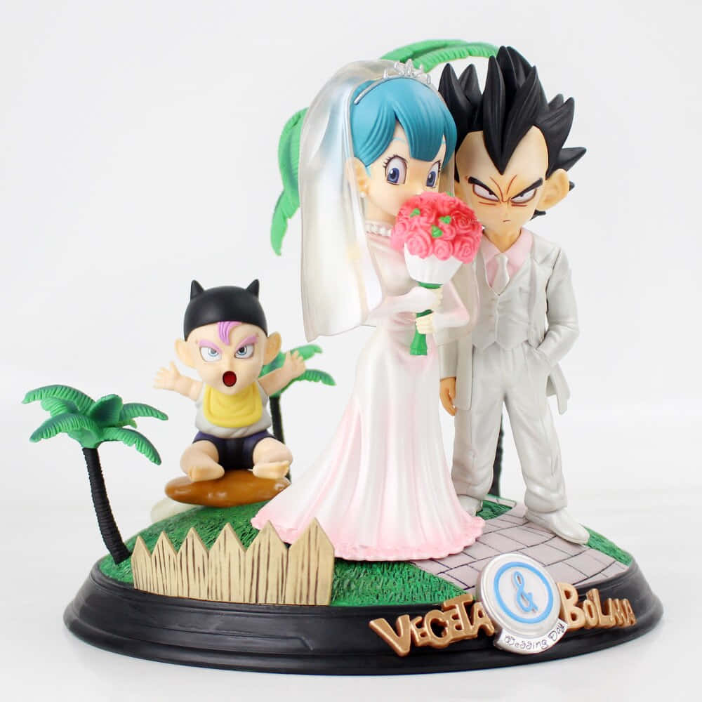 Vegeta's Family 桌布 壁紙 — 七龍珠中達爾和布瑪的婚禮人偶，手持粉紅玫瑰，他們的兒子特南克斯驚訝地看著。