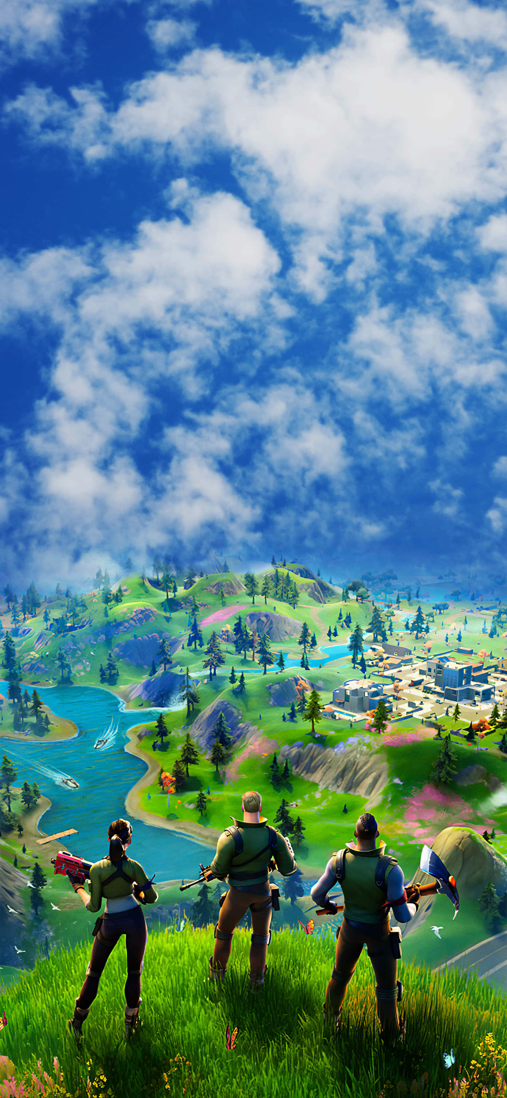 Fortnite iPhone 桌布 壁紙 — 三個 Fortnite 角色站在一個長滿草的懸崖上，俯瞰著一個充滿活力的山谷，山谷中有河流、森林和遠處的建築物，天空湛藍明亮。