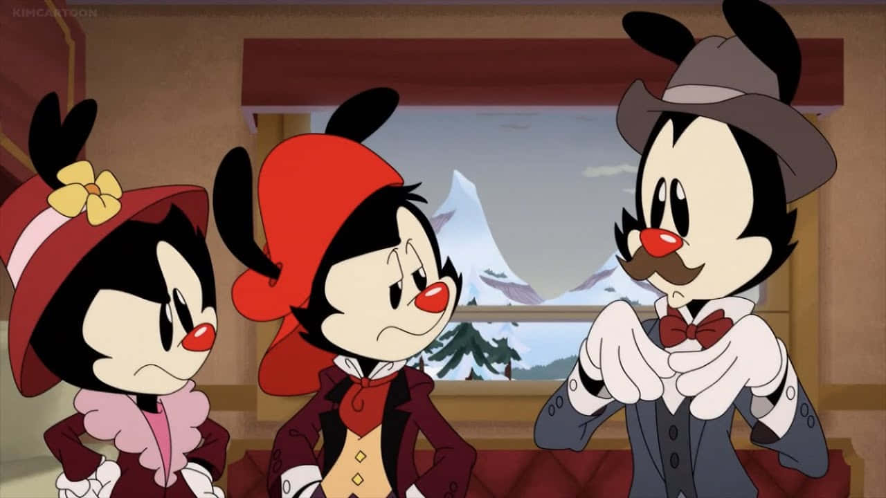 Animaniacs 桌布 壁紙 — 三個卡通角色在一間舒適的小屋中，窗外可見積雪的山脈。