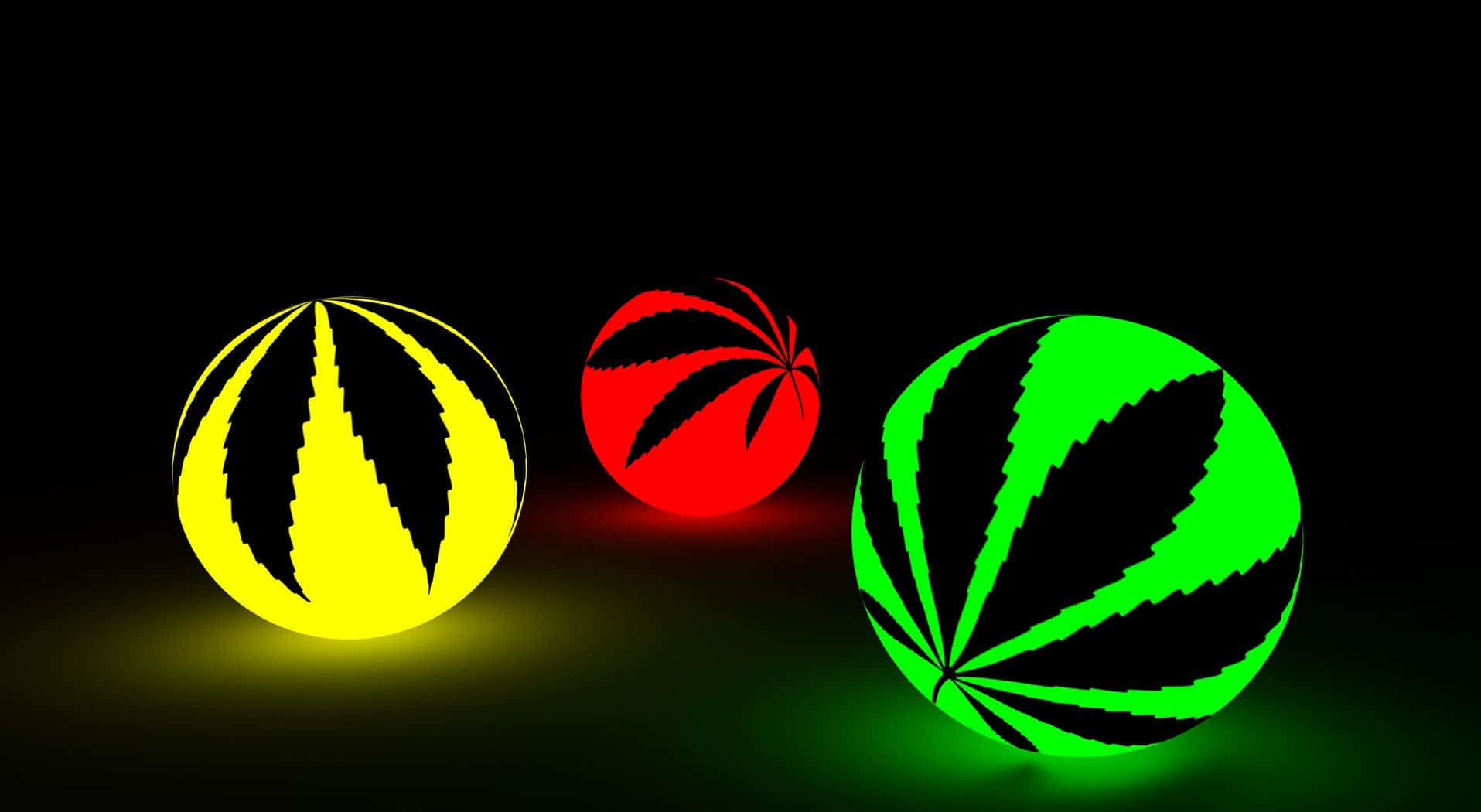 Psychedelic Weed 桌布 壁紙 — 三個帶有大麻葉圖案的發光球體，在黑色背景上發出鮮豔的黃色、紅色和綠色光芒。