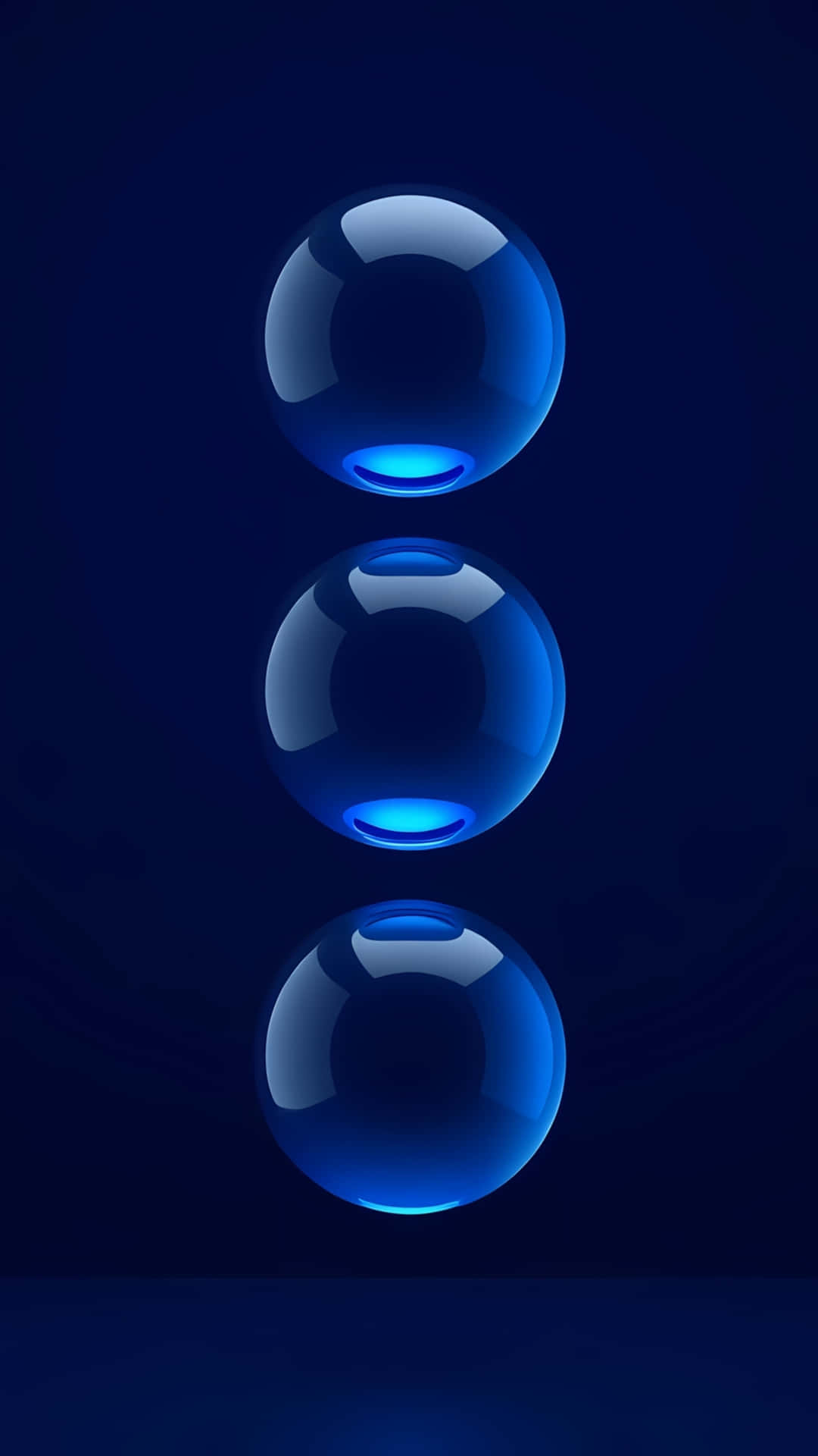 Abstract 3D Blue Glass Spheres Wallpaper 壁紙 — 三個發光的藍色球體垂直漂浮在深藍色漸變背景上，帶有柔和反射。