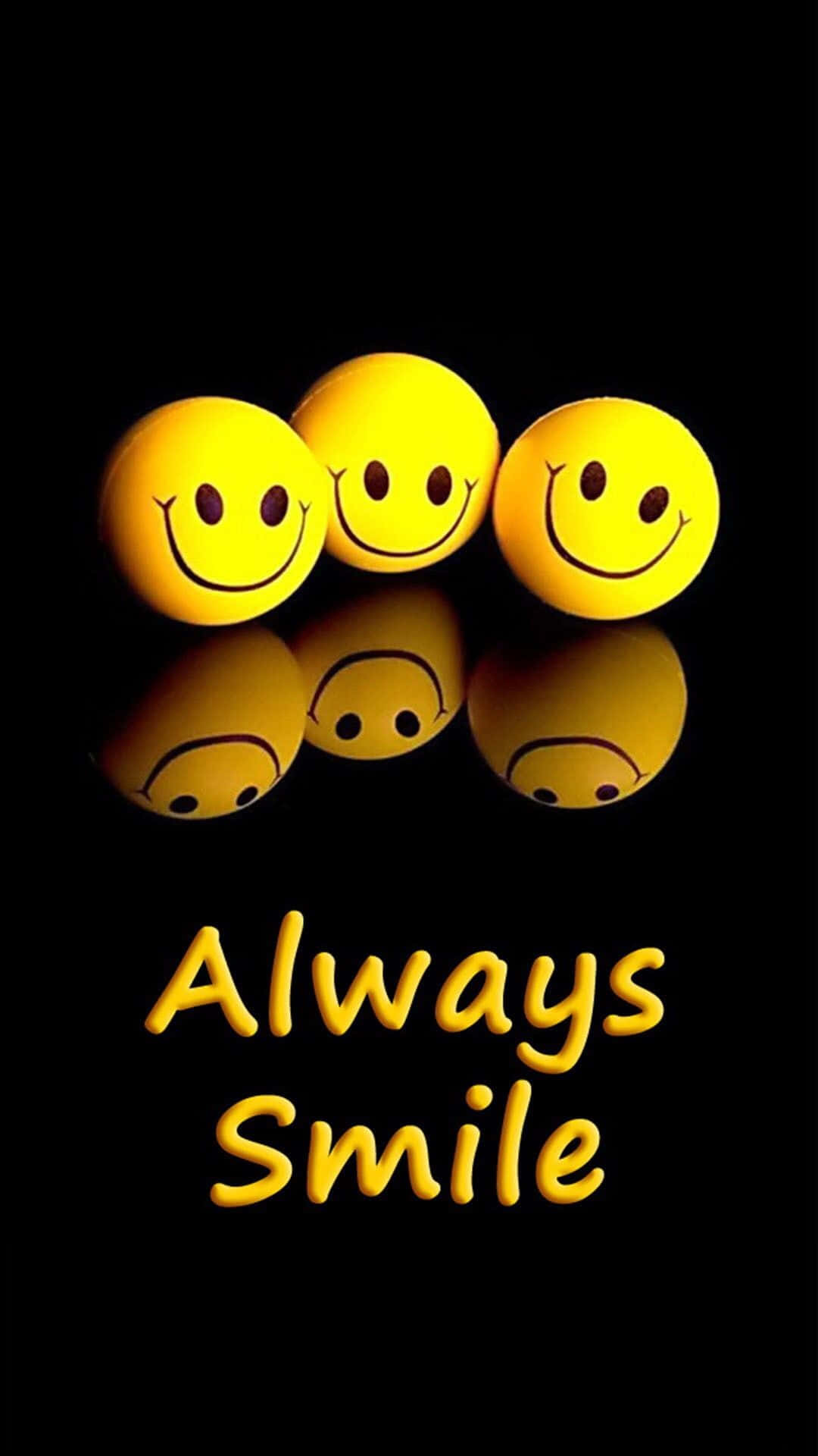 Smile 桌布 壁紙 — 三個發光的黃色笑臉球在黑色表面上反射，下方有 'Always Smile' 文字。