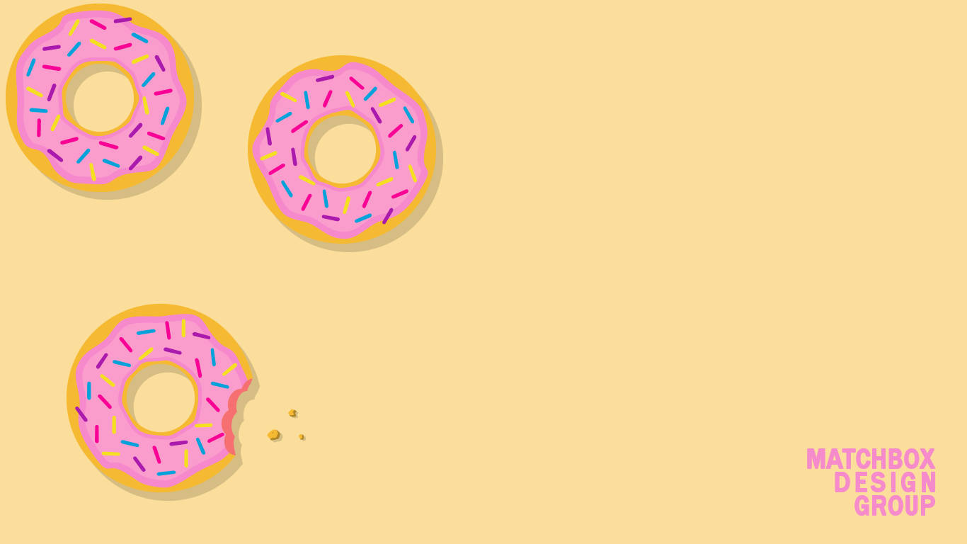 cute aesthetic pc 桌布 壁紙 — 三個色彩繽紛的糖霜甜甜圈漂浮在柔和的黃色背景上，其中一個被咬了一口，碎屑掉落。