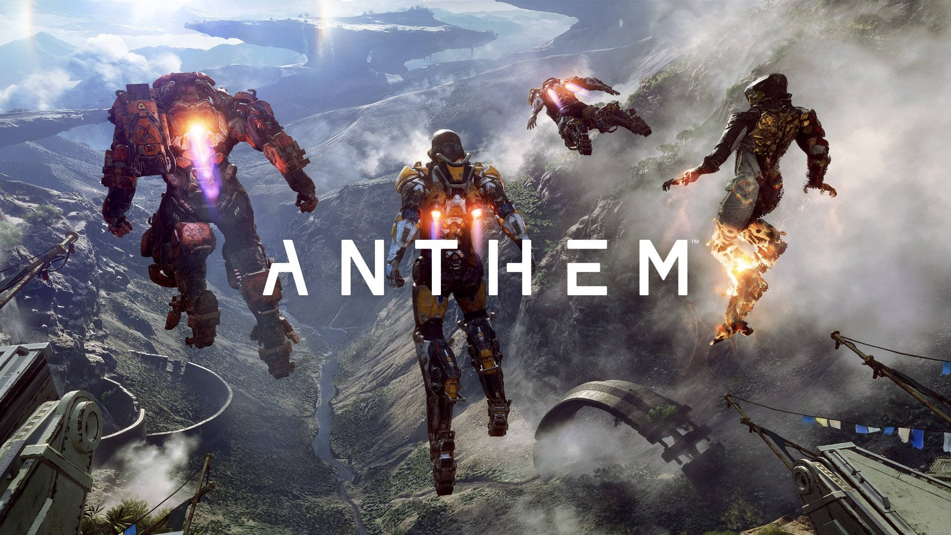 anthem 4K 桌布 壁紙 — 三個裝甲角色在迷霧山頂翱翔，手持發光武器，中間有ANTHEM字樣。