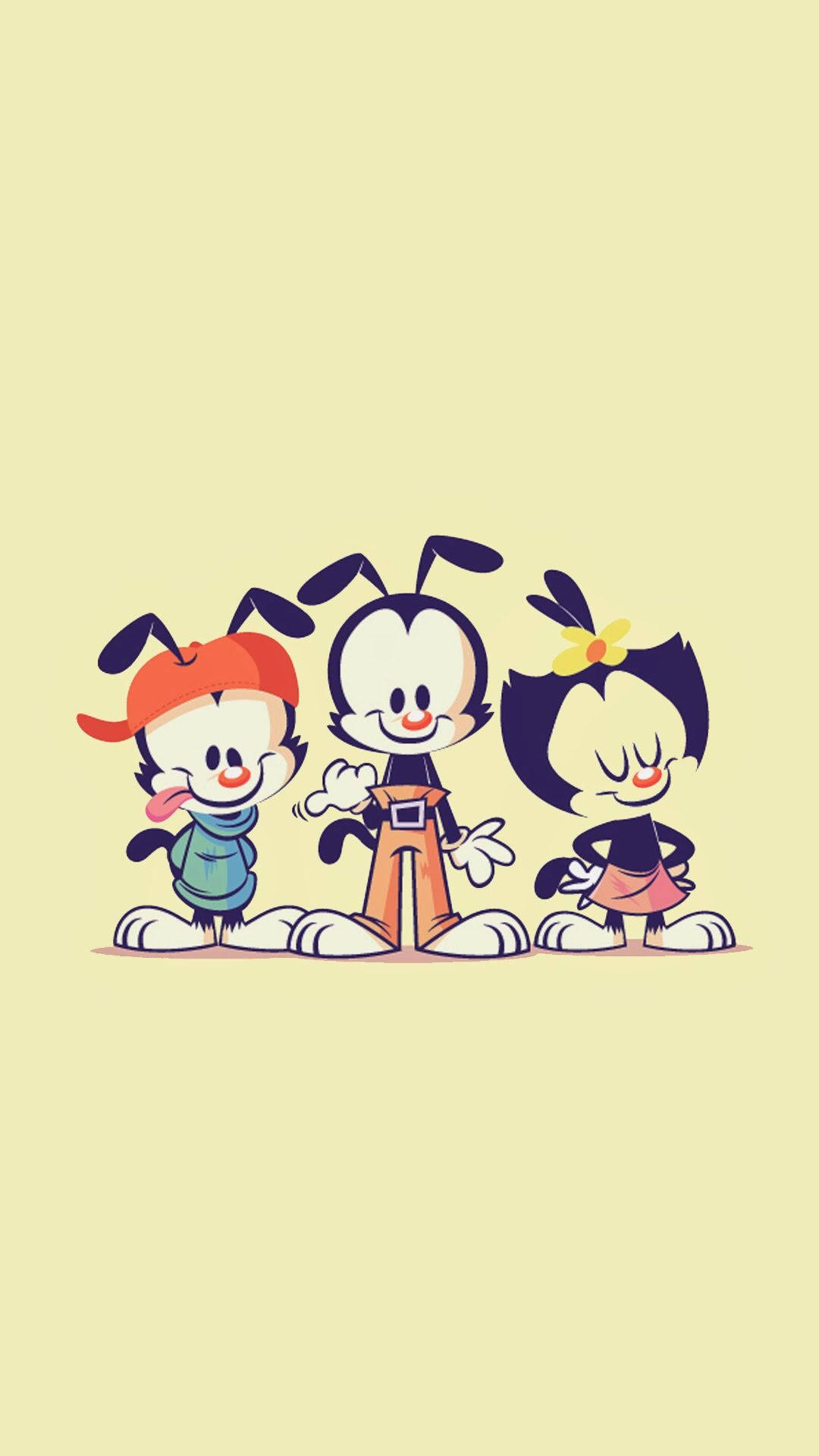 Animaniacs 桌布 壁紙 — 三個開心的卡通角色，有大眼睛和俏皮的姿勢，站在柔和的黃色背景前。