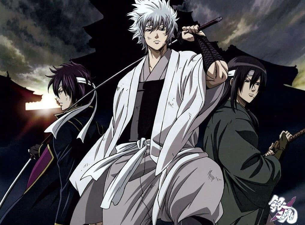 銀魂 桌布 壁紙 — 三名動畫武士手持刀劍，在暴風雨黃昏的天空下，矗立於傳統日本建築的剪影之上。
